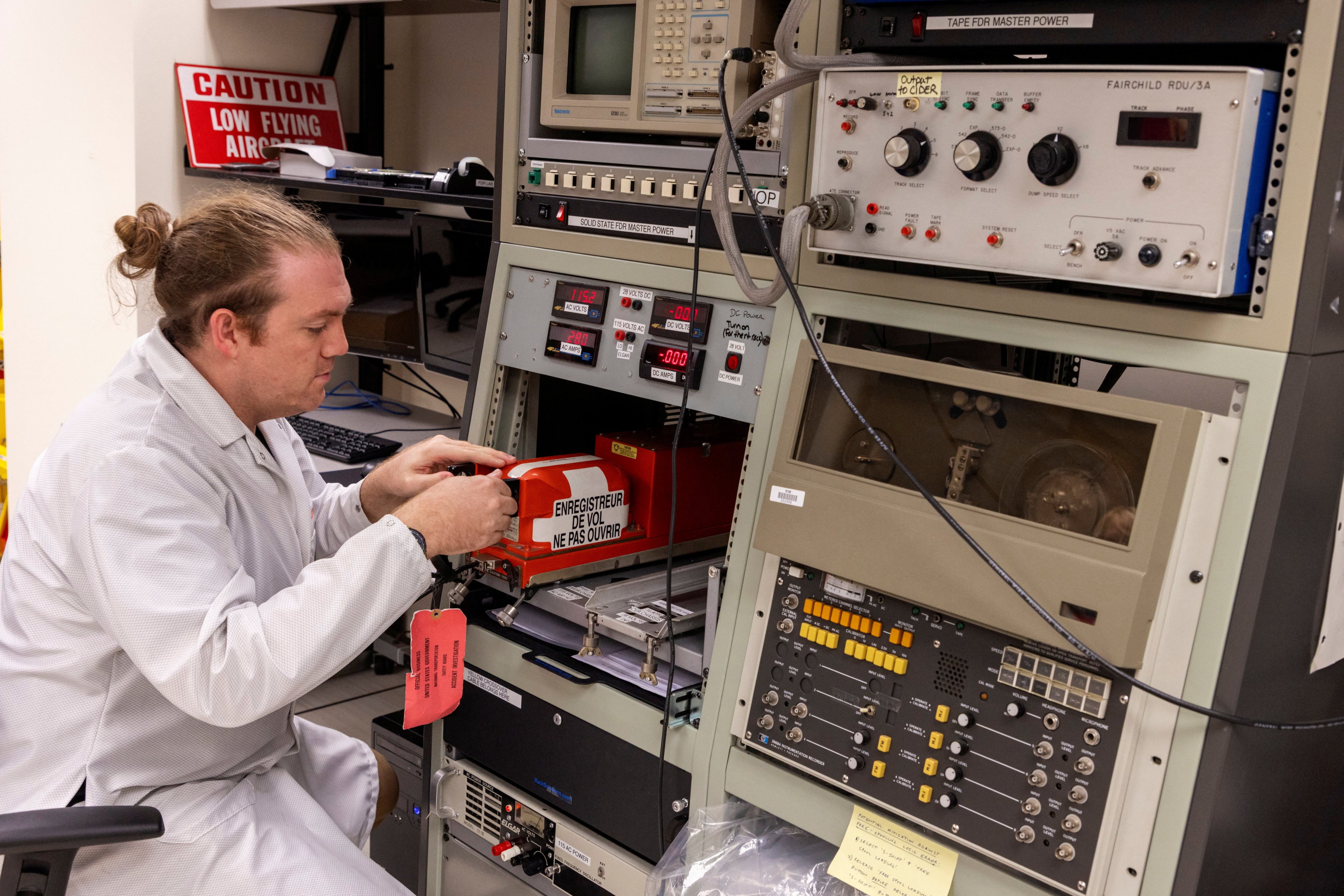 An investigator works with the flight data recorder. Photo: NTSB via Reuters