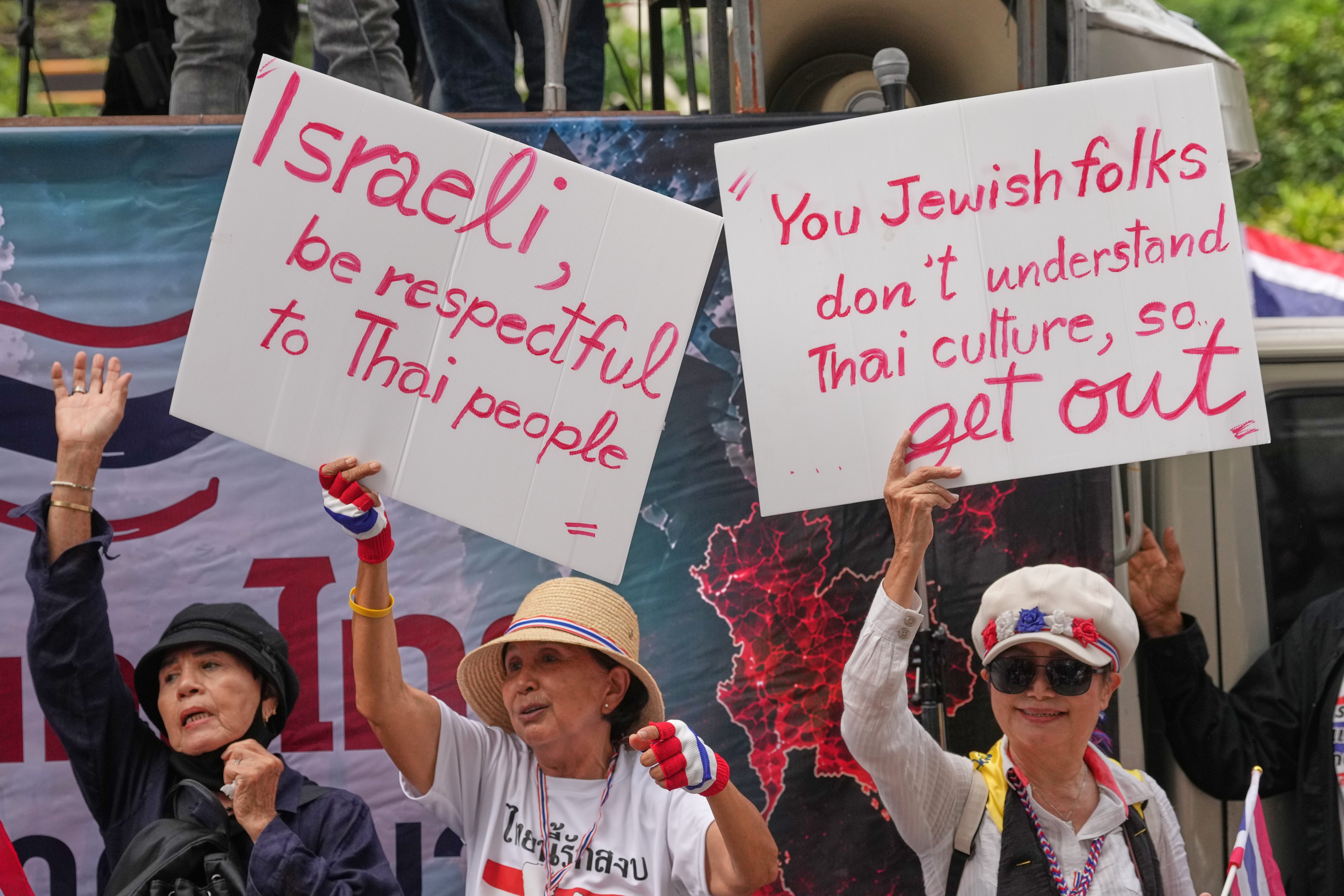 Protesters wave placards during a rally outside the Israeli Embassy in Bangkok on Thursday. Photo: AP