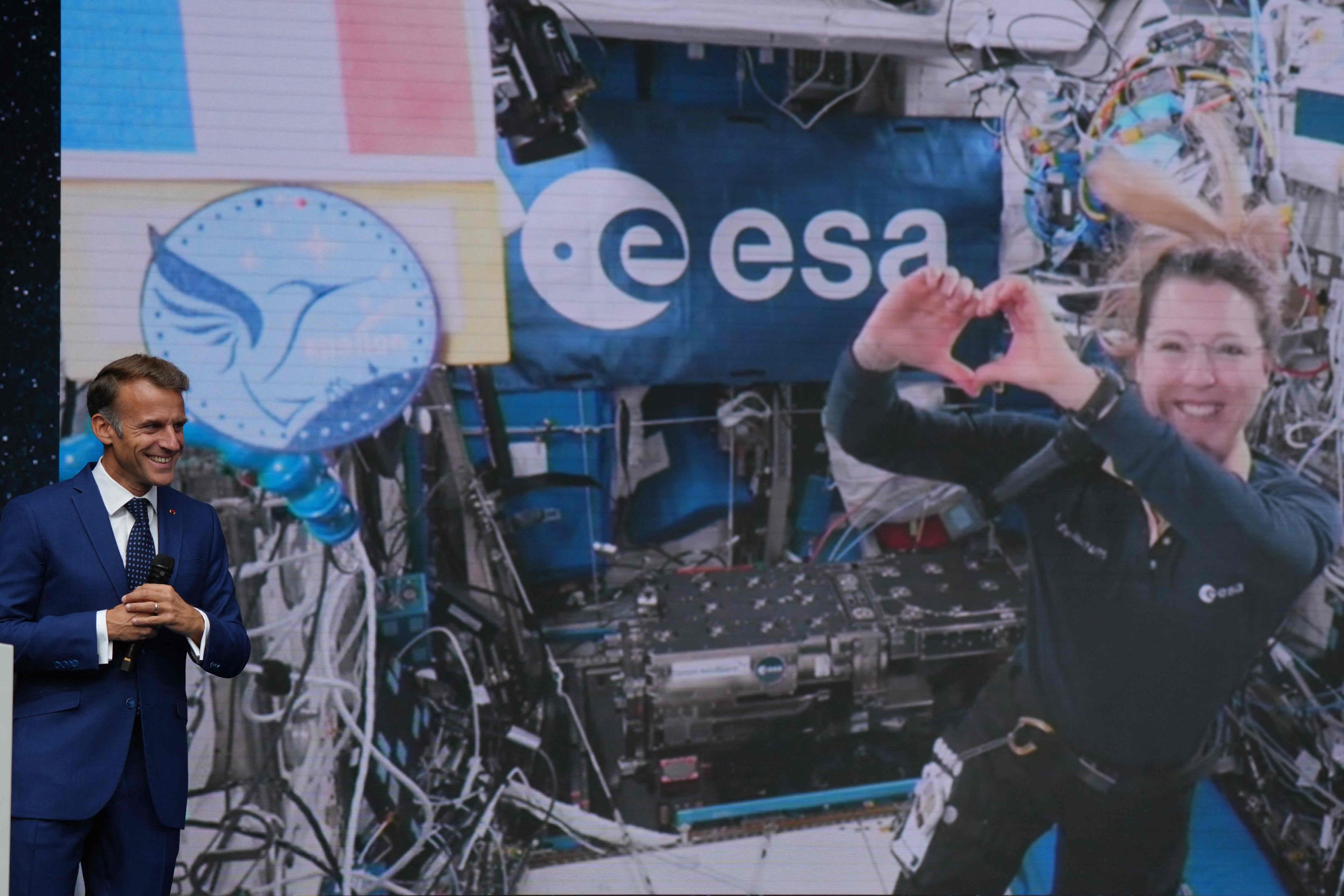France’s President Emmanuel Macron listens to French astronaut Sophie Adenot during a live video connection from the International Space Station at the International Space Summit at the Grand Palais in Paris on Thursday. Photo: AFP