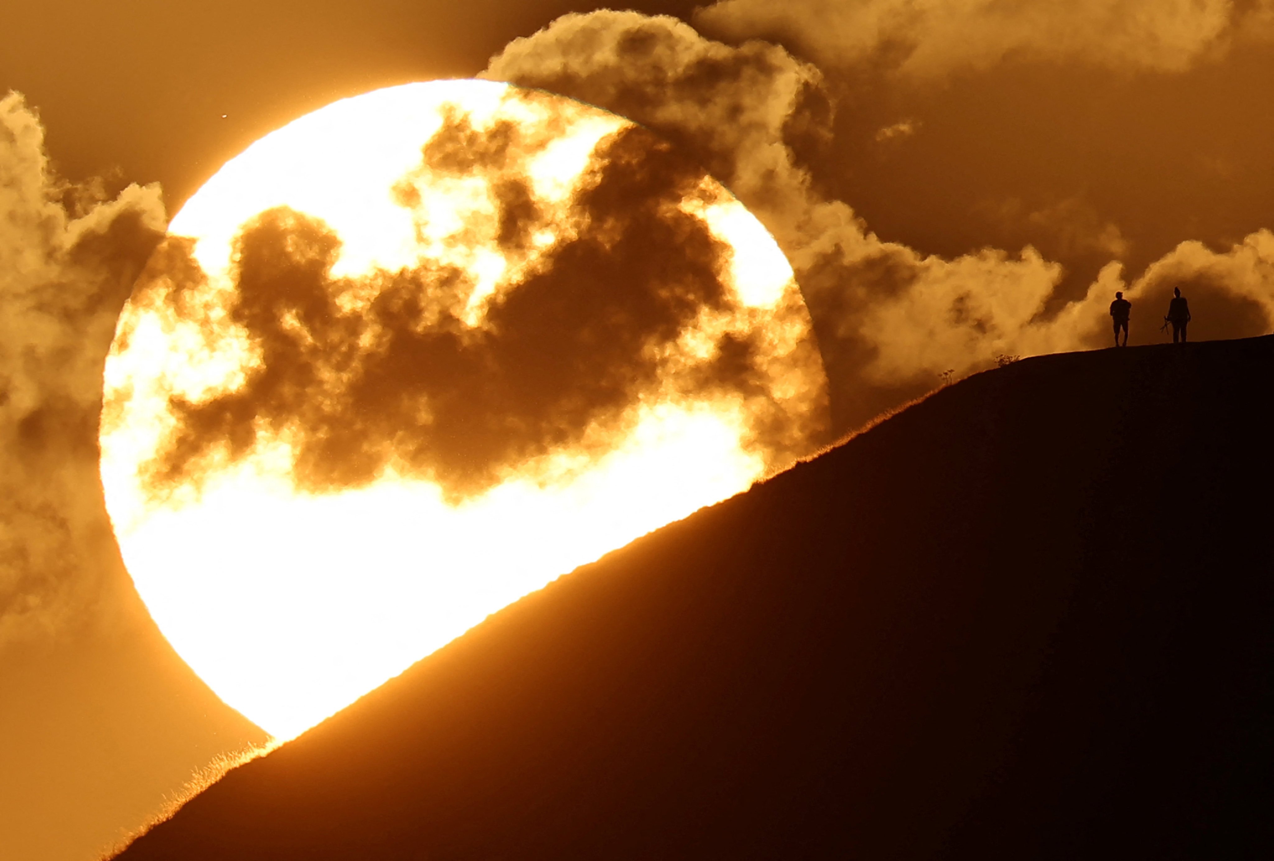 The sunrise on Glastonbury Tor during extreme hot weather in Britain in August. Photo: Reuters