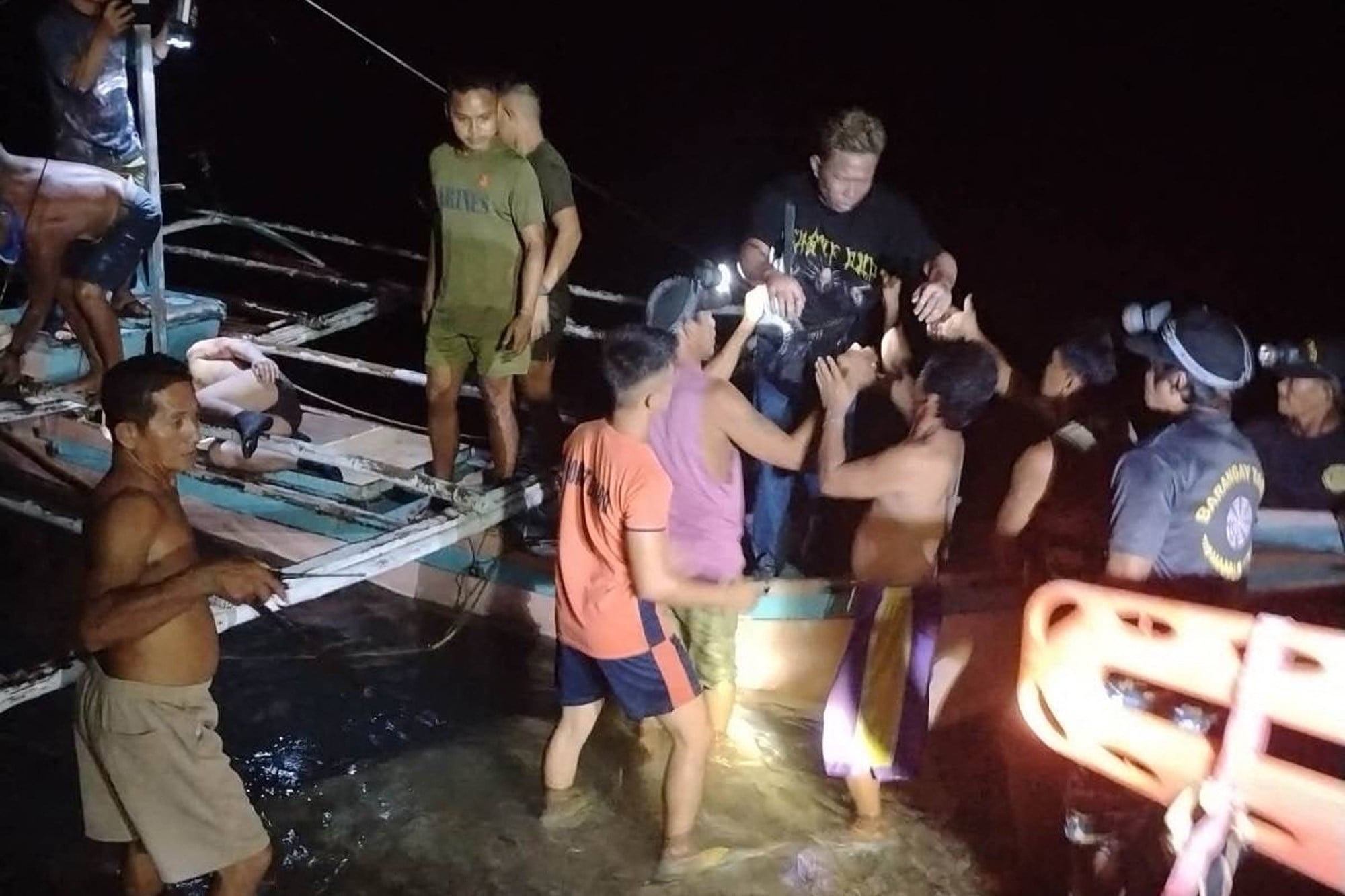 Volunteer fisherfolk help the survivors from the ferry that caught fire off Palawan, Philippines, on Wednesday. Photo: PCG/AFP