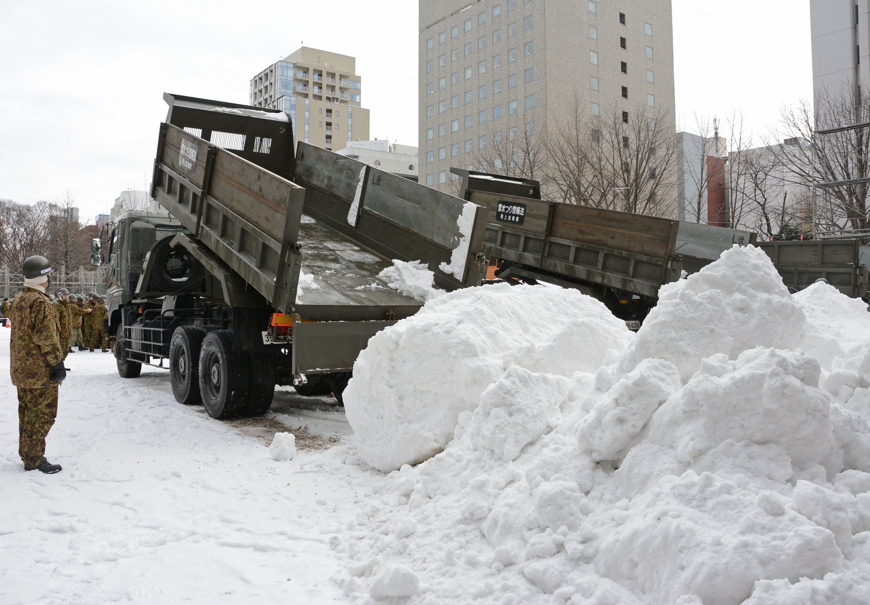 Snow is carried to Odori Park in Hokkaido, northern Japan, in January 2020, to create snow and ice sculptures for the Sapporo Snow Festival. Photo: Kyodo