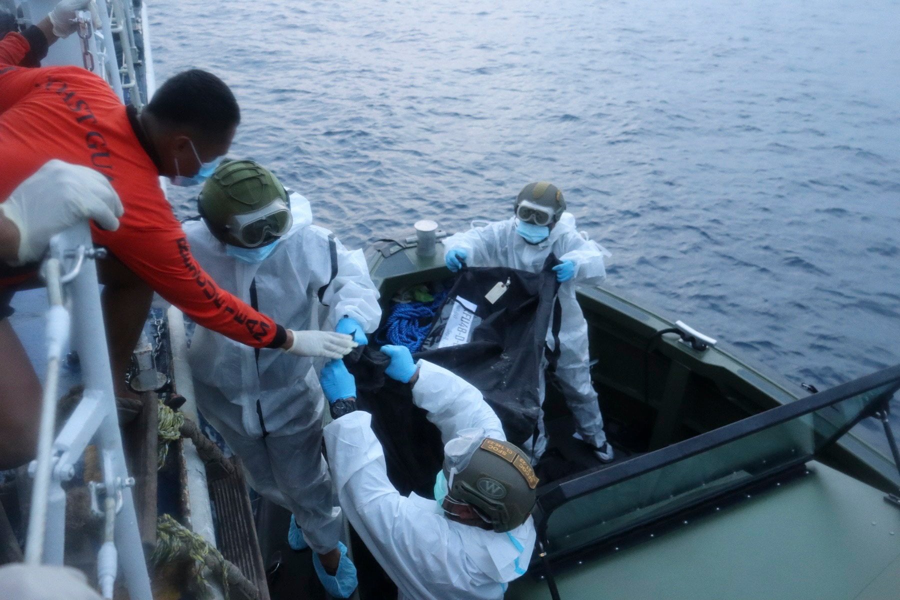 Rescuers transporting remains of victims to a vessel after recovery from the ferry MV June Aster off Palawan province, the Philippines, on Friday. Photo: EPA / Philippine Coast Guard
