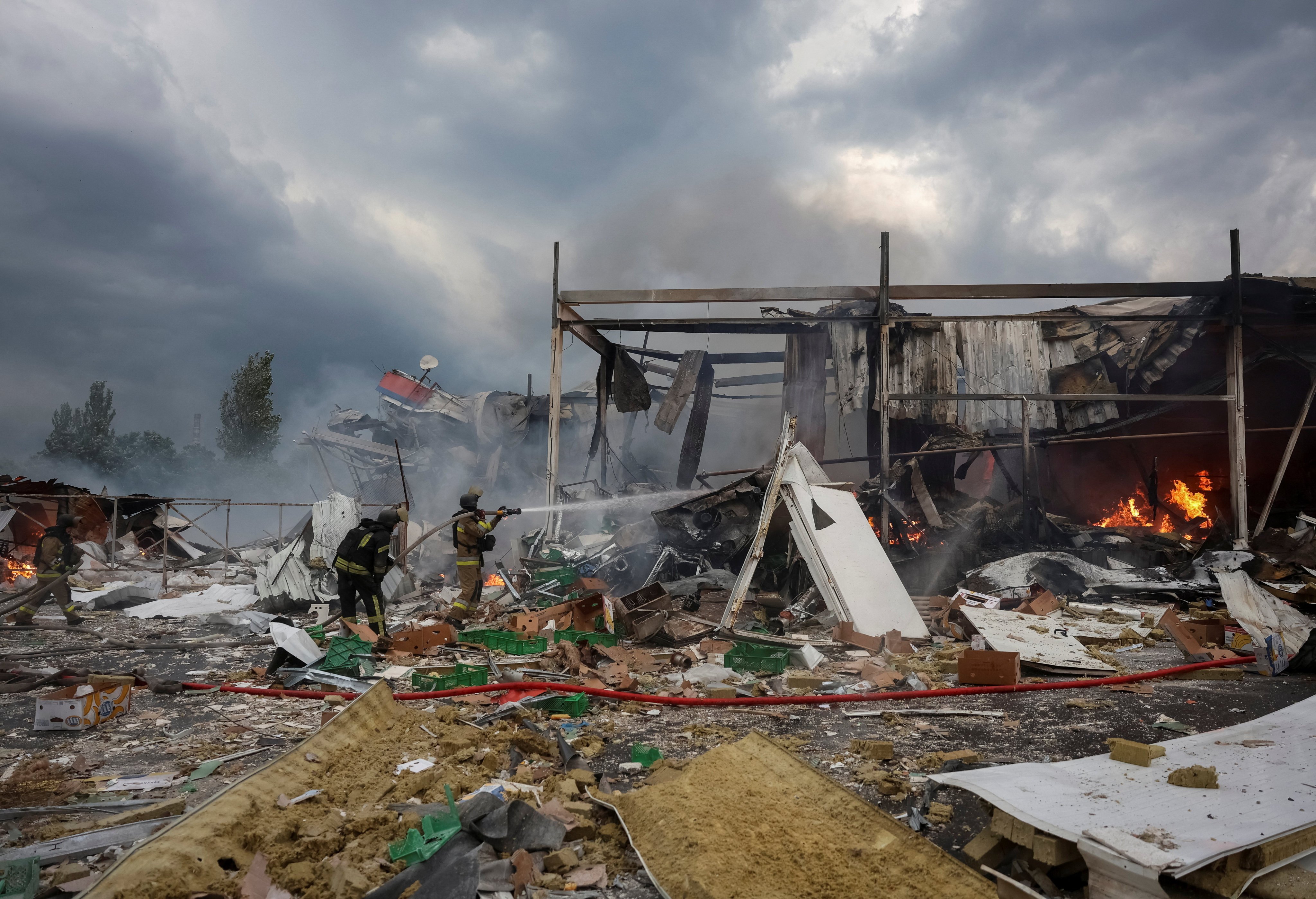 Firefighters work at the site of a supermarket hit by a Russian air strike in Kramatorsk, Donetsk region, Ukraine, in July. Photo: Reuters