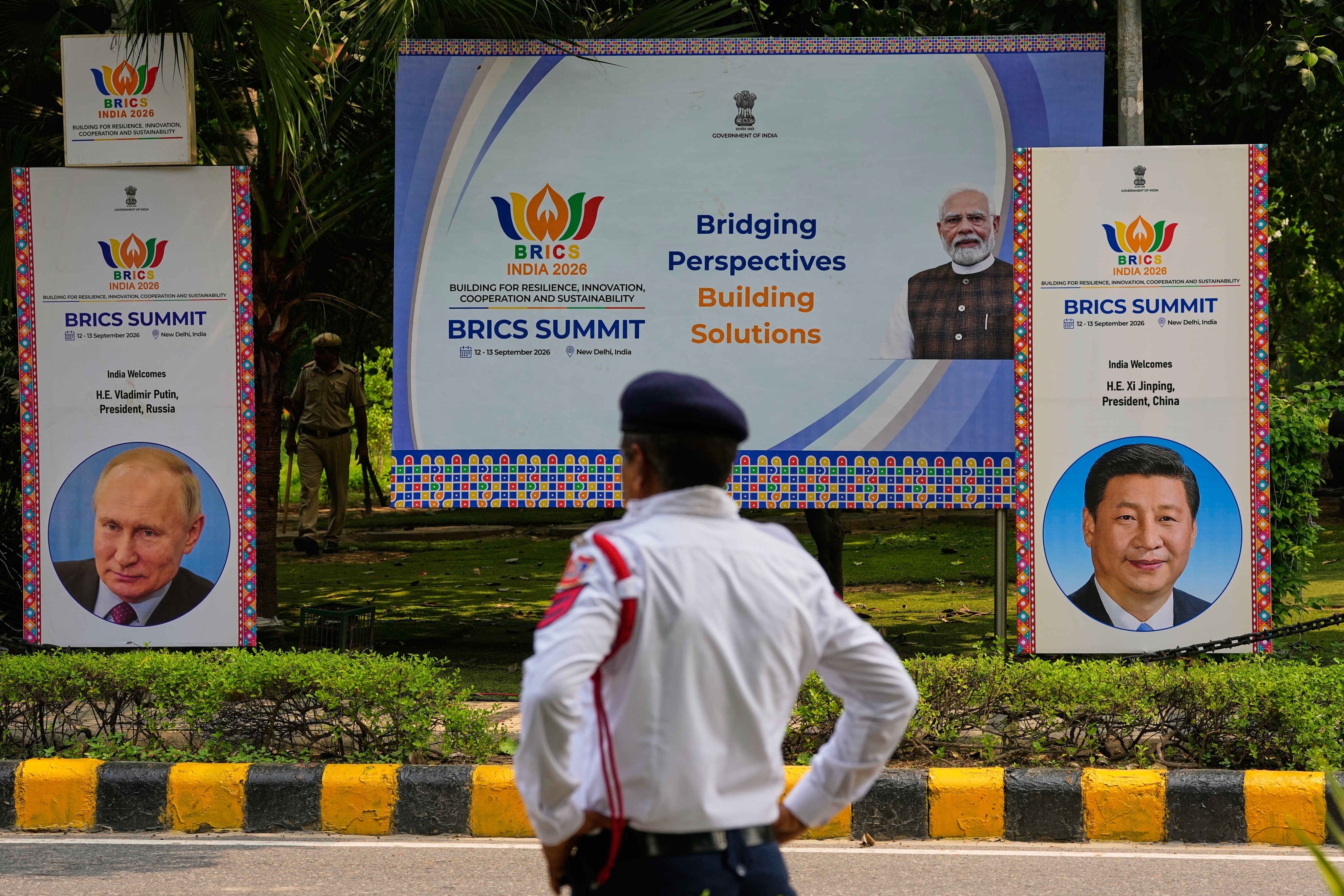 Security officers stand guard beside Brics summit banners bearing images of Indian Prime Minister Narendra Modi, Russian President Vladimir Putin and Chinese President Xi Jinping in New Delhi, India, on September 11. Photo: AP