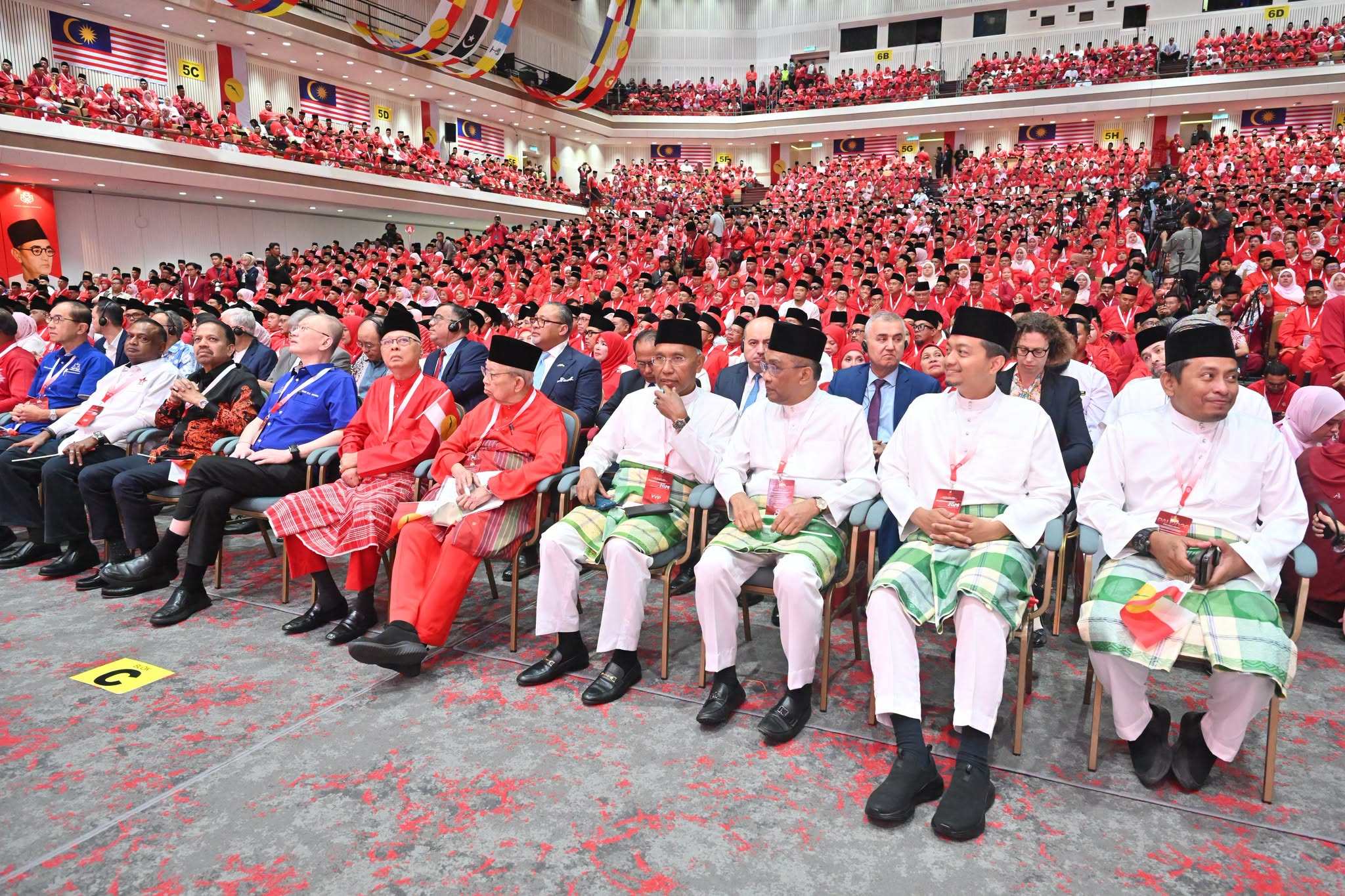PAS members sit in the VIP area at Umno’s general assembly on Friday. Photo: Facebook/mediaumnomalaysia