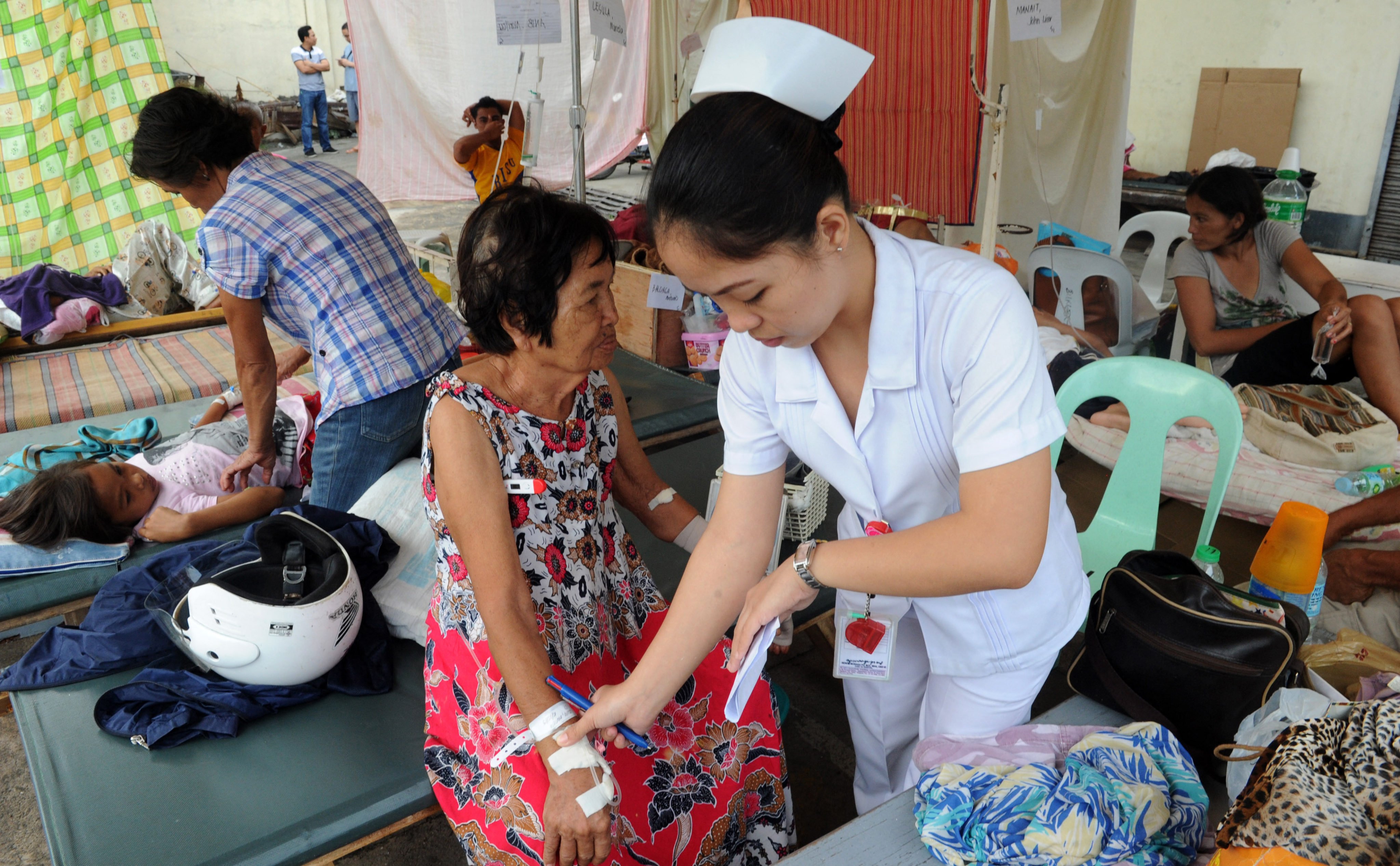 A Filipino nurse attends to an elderly woman at a temporary shelter in Tagbilaran city following an earthquake in 2013. The Philippines certifies about 41,000 carers per year. Photo: AFP