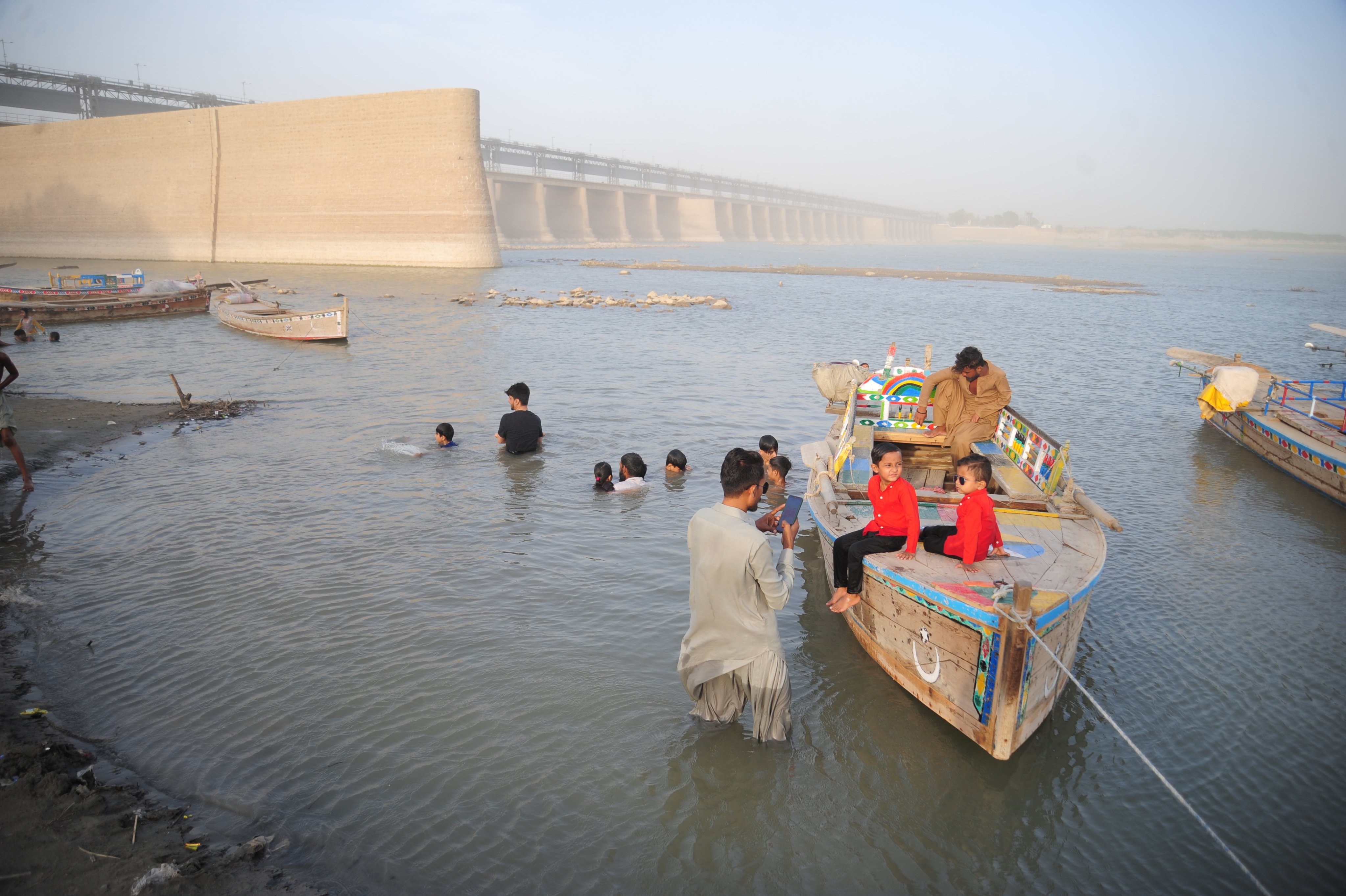 People gather on the Indus River near Hyderabad, Sindh province, Pakistan, in May 2025. The Indus River system sustains roughly 300 million people across South Asia. Photo: EPA