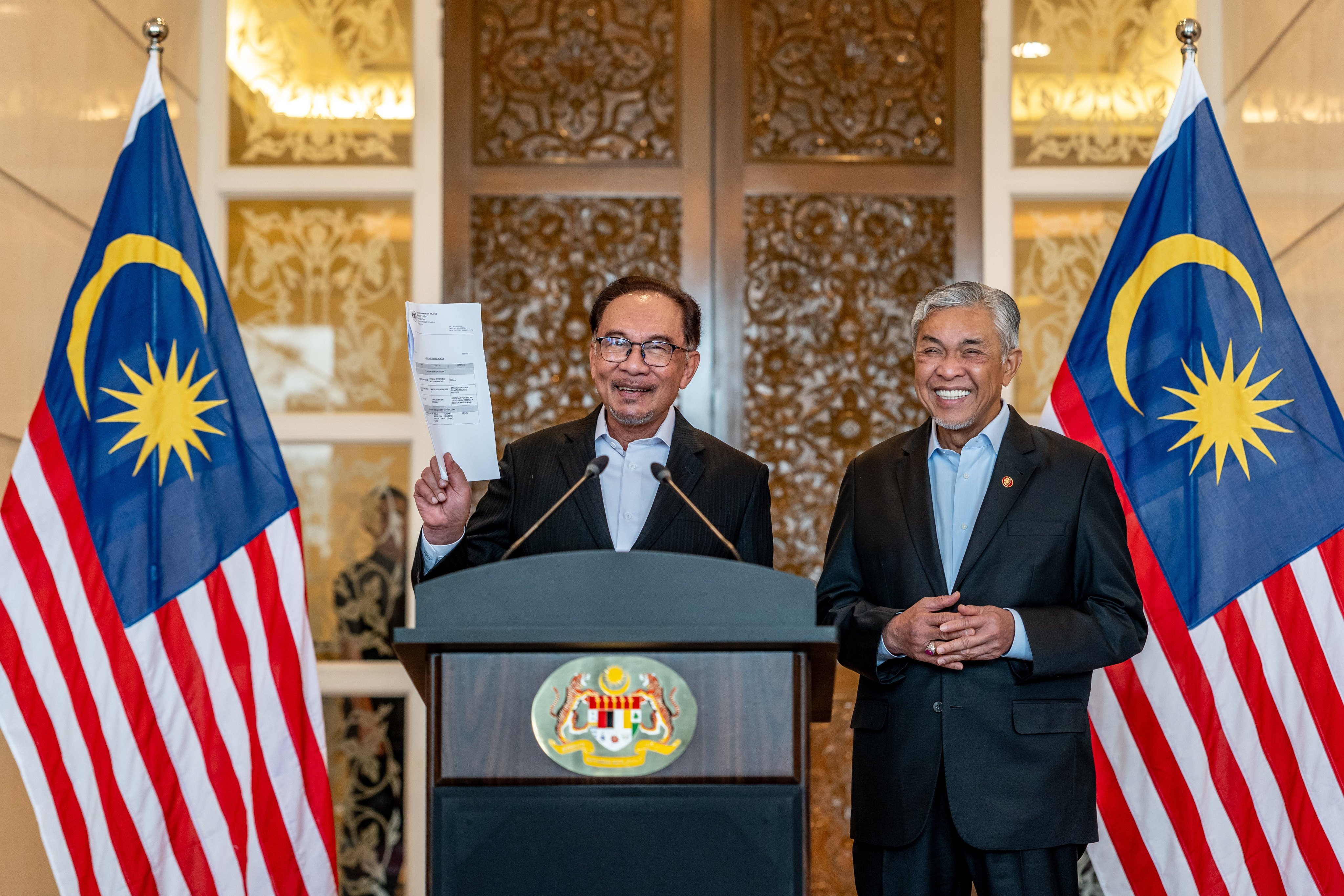 Prime Minister Anwar Ibrahim (left) announces his cabinet reshuffle in 2023 as Deputy Prime Minister Ahmad Zahid Hamidi looks on. Photo: Handout
