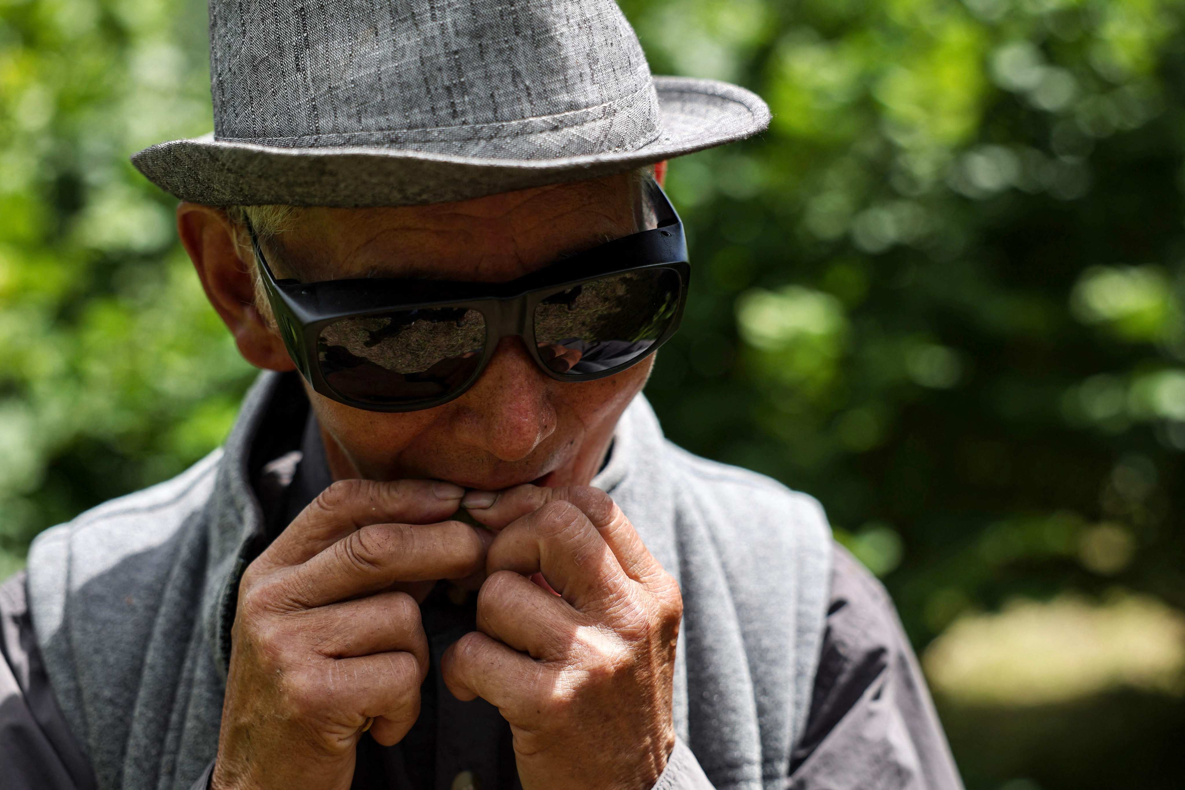 Farmer Dawa Dhendup cracks open a hazelnut at his farm in Bhutan’s Thimphu region. Photo: AFP