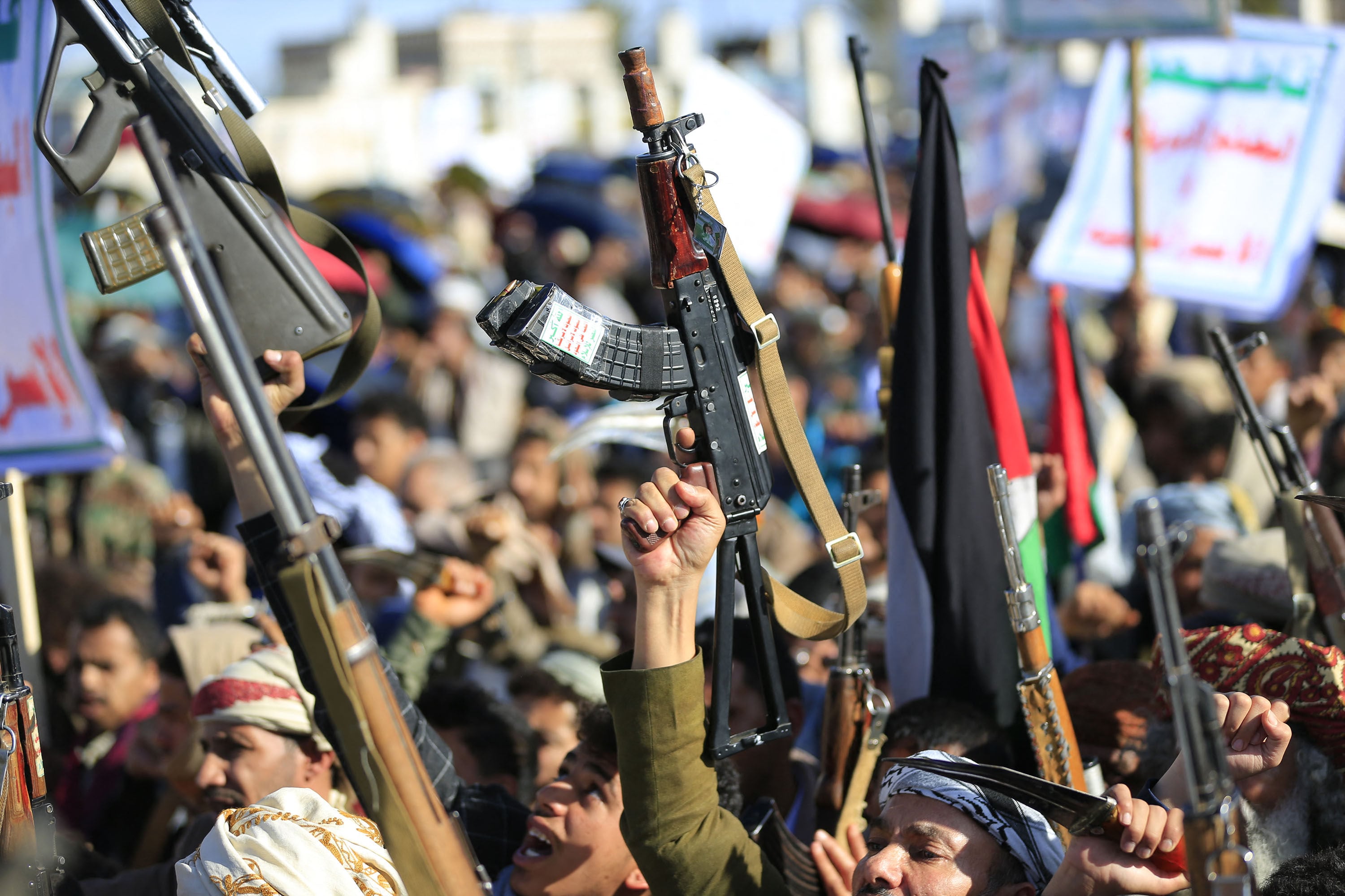 Houthis brandish their weapons as they rally in the Yemeni capital of Sanaa in March. Photo: TNS