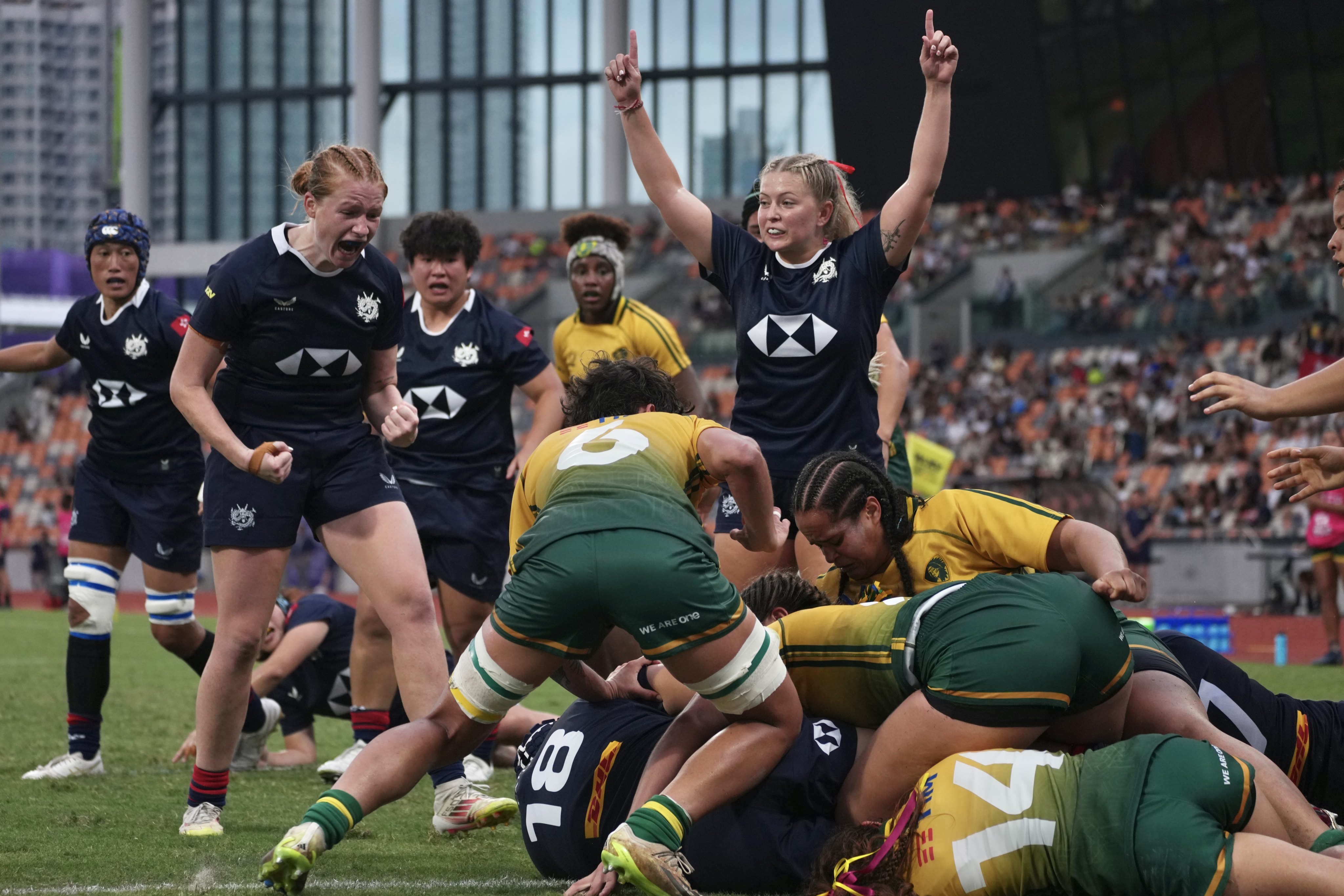 Hong Kong (in blue) celebrate a try against Brazil in their WXV Global Series Challenger match at Kai Tak Youth Sports Ground on Sunday. Photo: Karma Lo