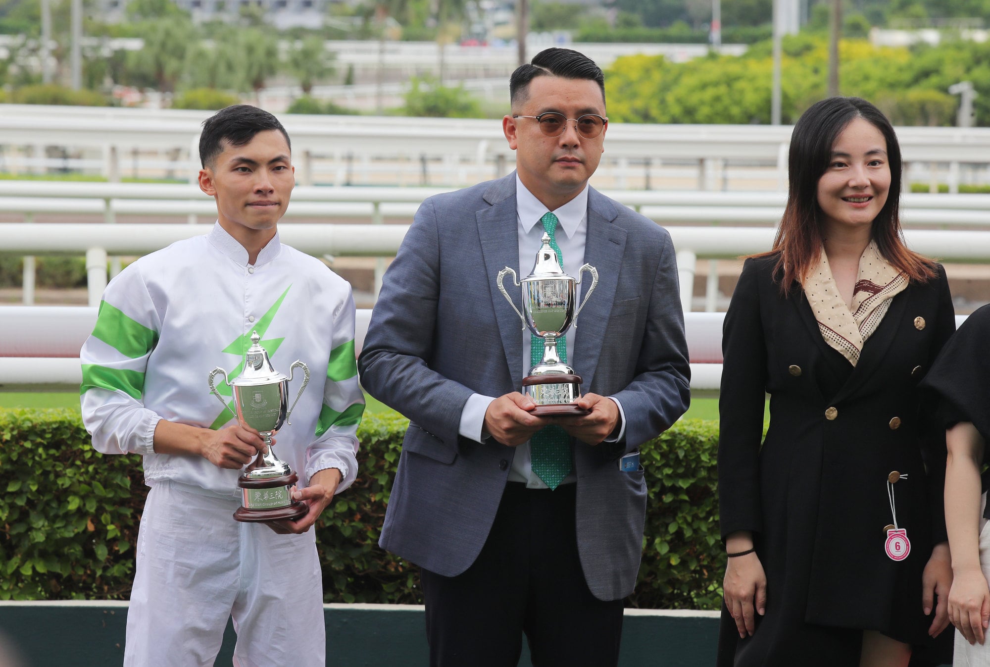 Trainer Pierre Ng and Ellis Wong collect their trophies at Sha Tin. Trainer Pierre Ng and Ellis Wong collect their trophies at Sha Tin.