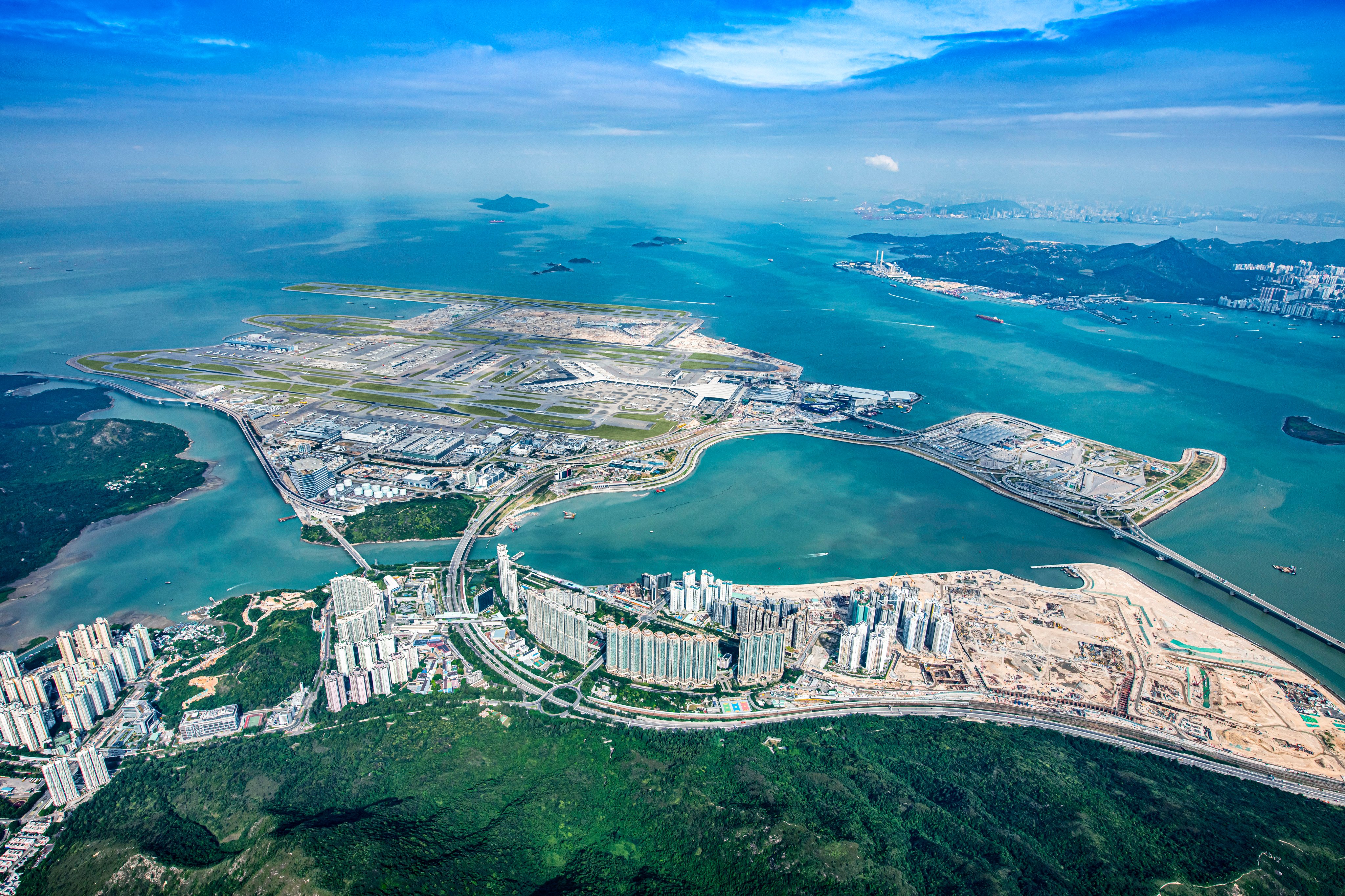 Construction of the three-runway system at Hong Kong International Airport involved reclaiming approximately 650 hectares of land, equivalent to 34 Victoria Parks or 900 standard football pitches.