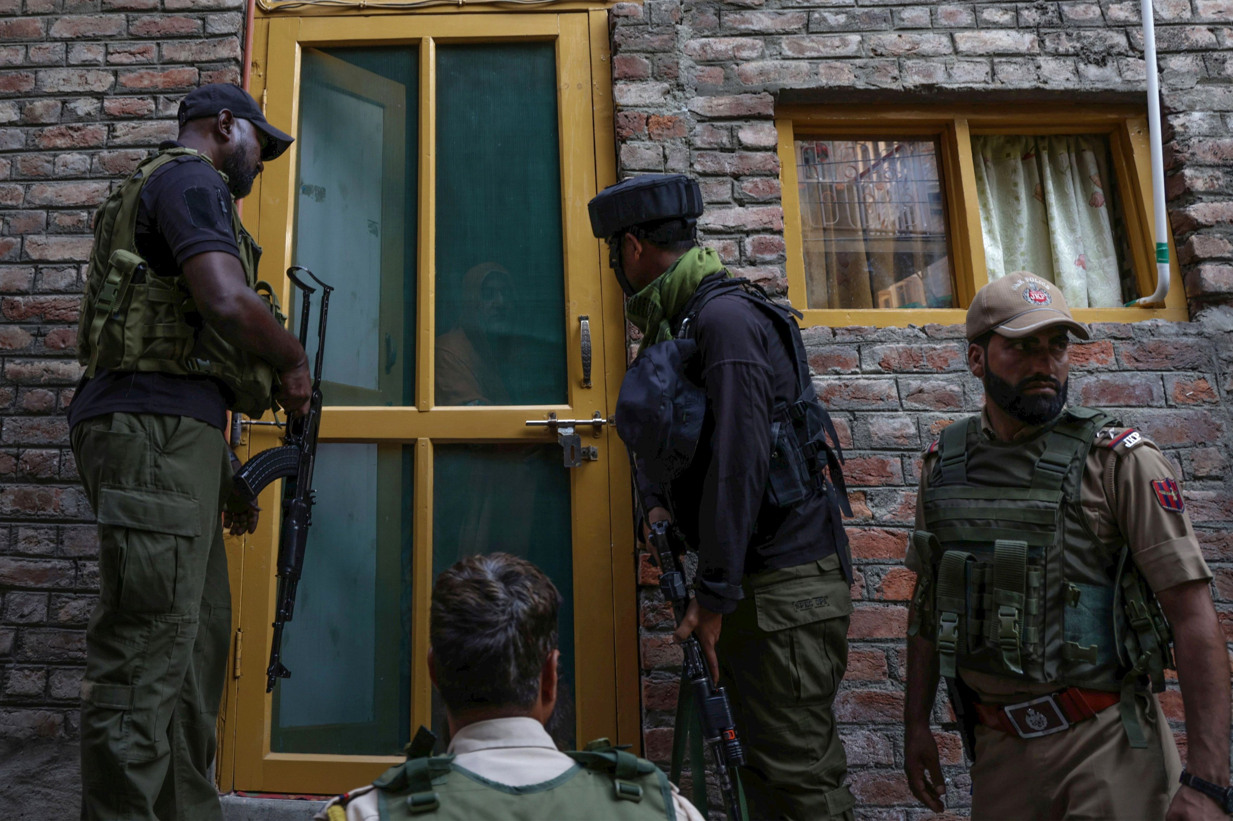 Indian police and paramilitary personnel conduct a door-to-door search operation in Srinagar, Indian-administered Kashmir, on Saturday. Photo: EPA