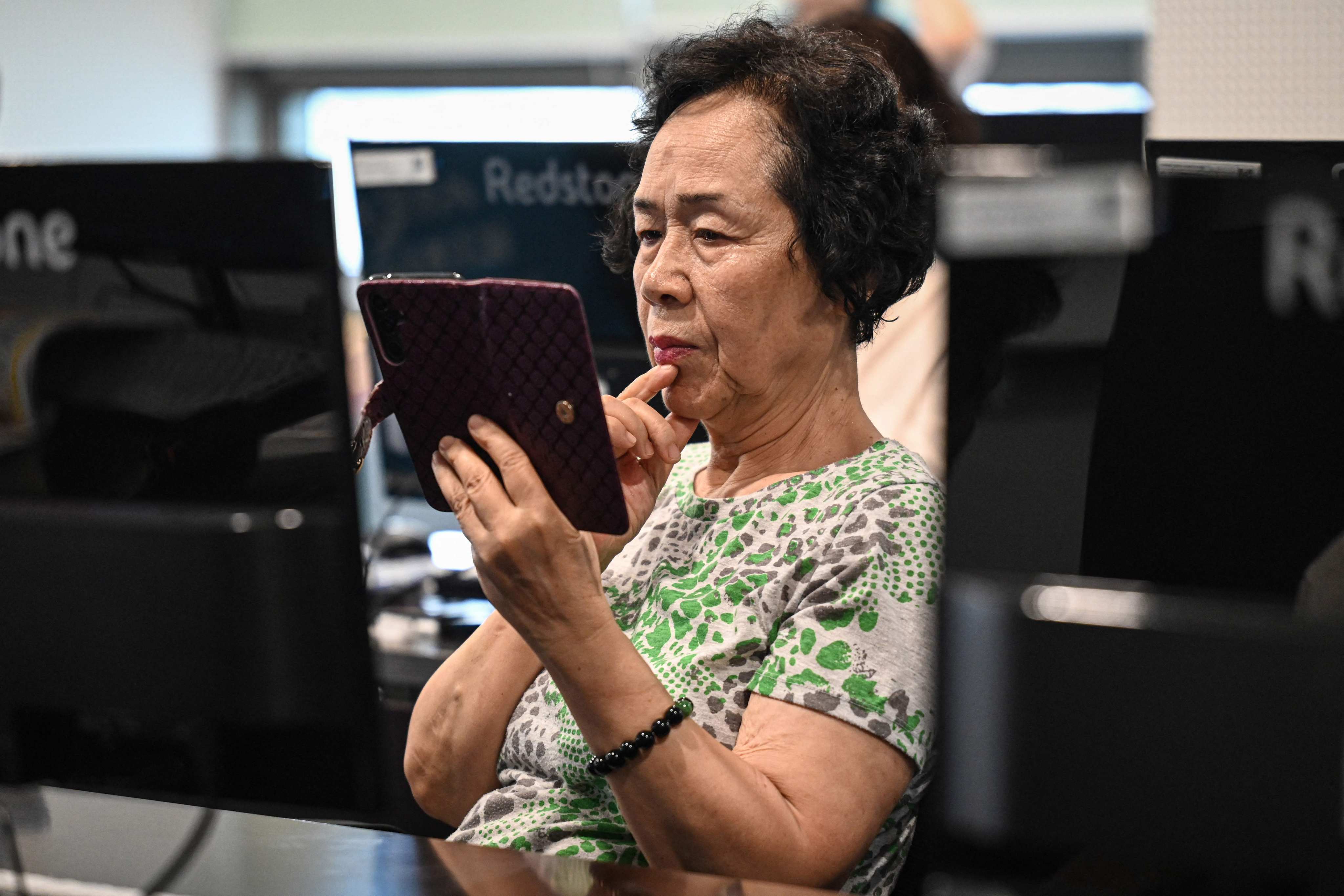 An elderly woman attending a class on how to use AI-powered applications at Seoul Open City University in South Korea in July. Photo: AFP