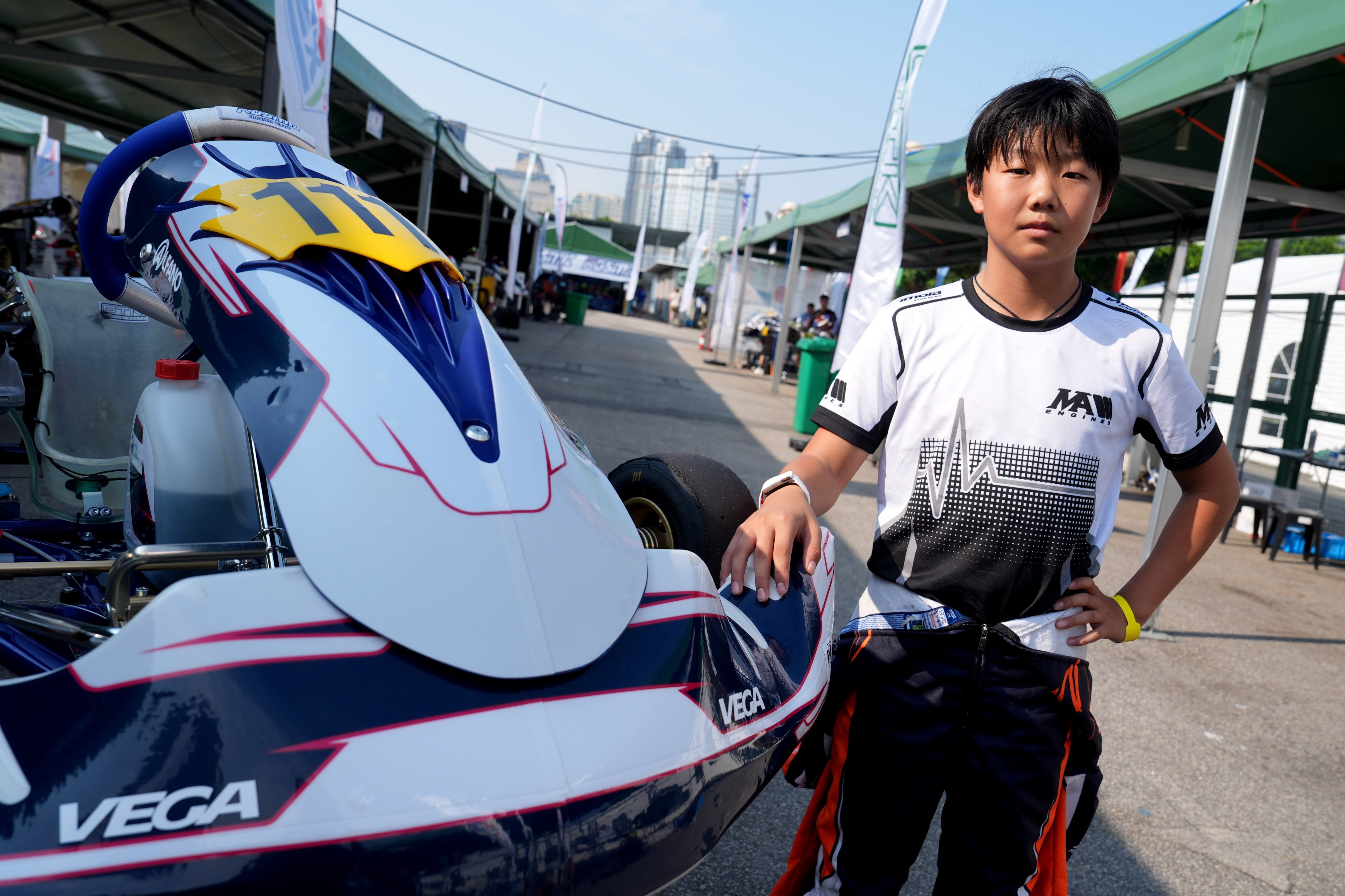 John Han poses with the kart that delivered him the 2026 Junior FIA Karting Arrive and Drive Asia-Pacific Championship title. Photo: Elson Li