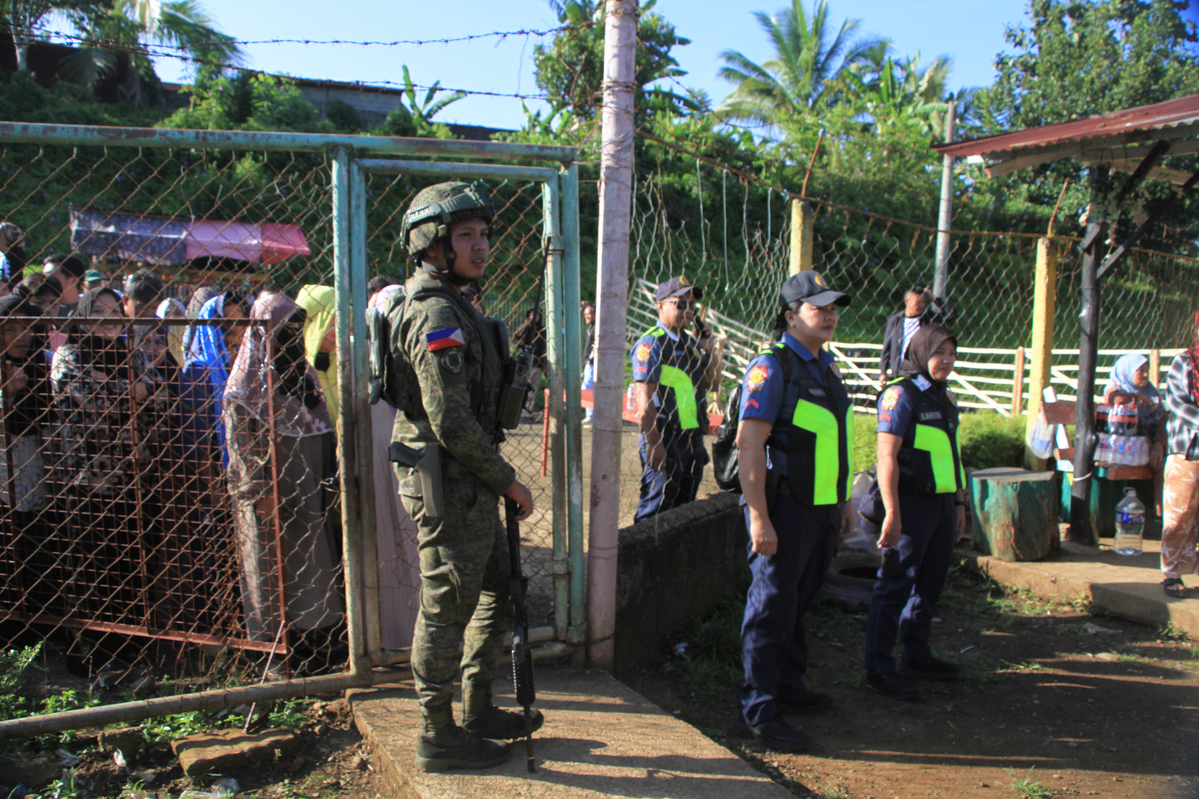 Security forces stand guard at a voting centre during the Bangsamoro parliamentary election at a school in Saguiaran, on Monday. Photo: AP