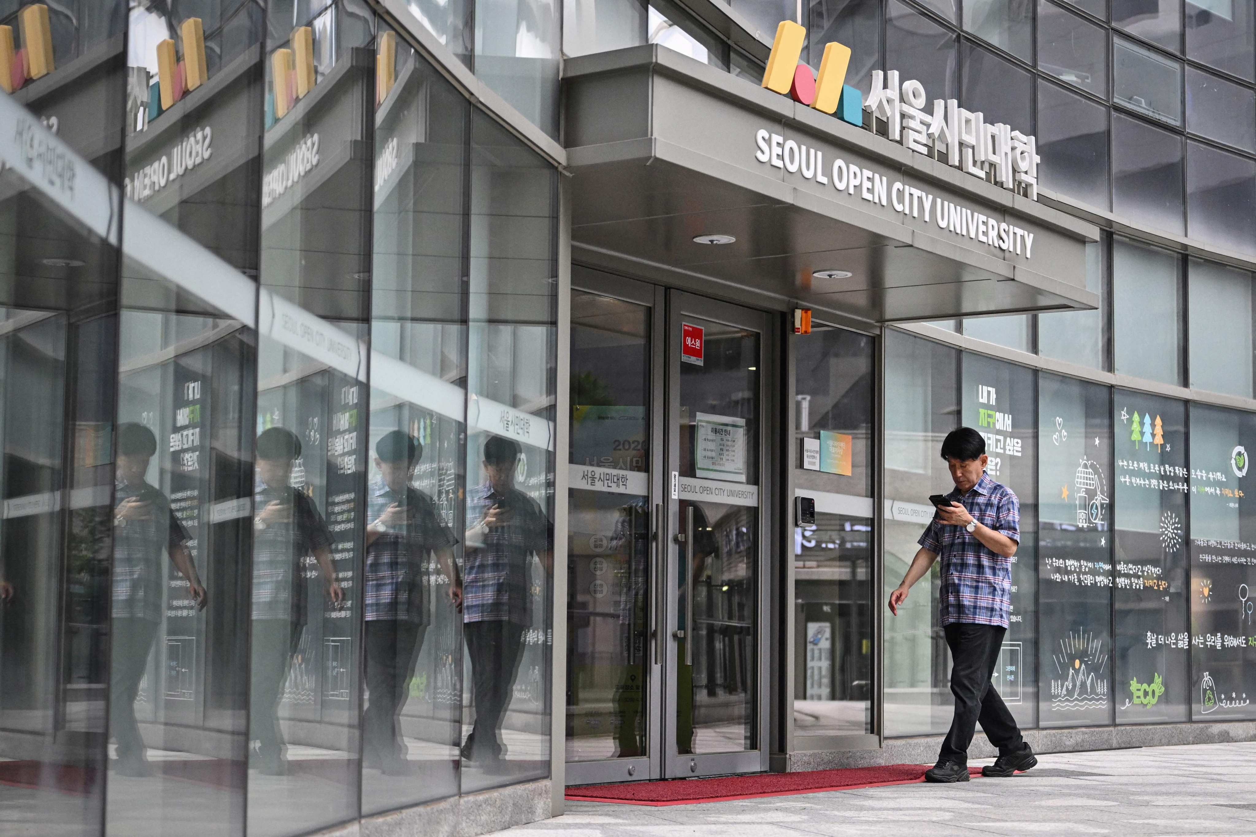 A man entering the Seoul Open City University for digital skills training in South Korea in July. Photo: AFP