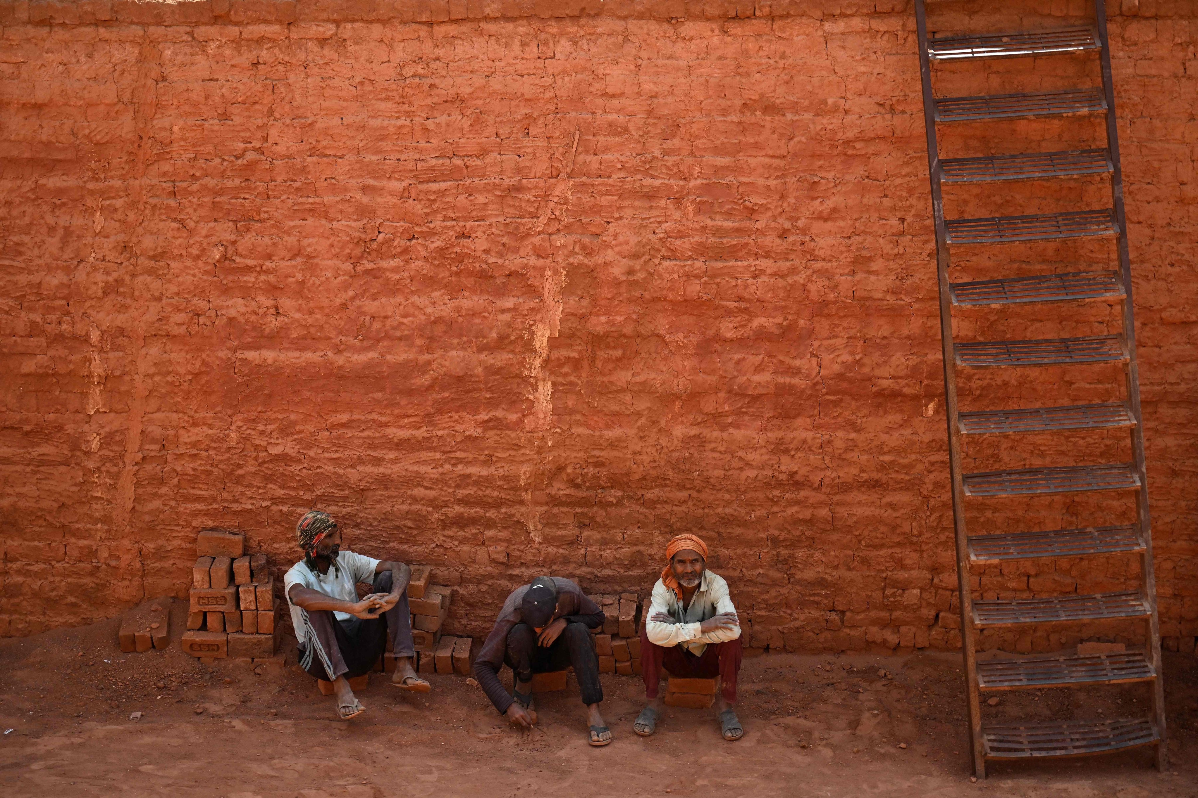 Indian migrant labourers rest at a brick kiln on the outskirts of Srinagar in August. Since 2019, at least 24 migrant workers have been killed in militant attacks across the territory, according to local media reports. Photo: AFP