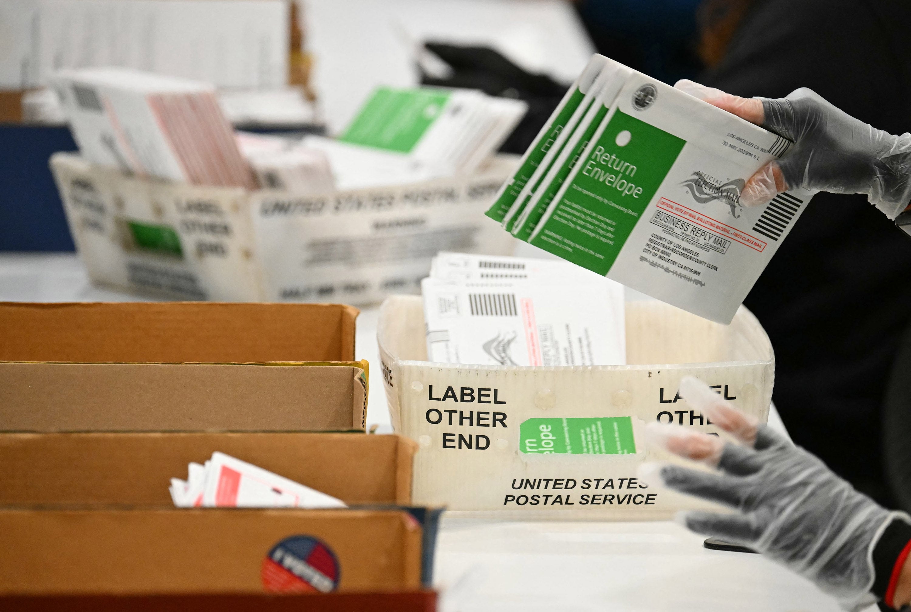 Election workers process mail-in ballots at the Los Angeles County Ballot Processing Centre during California’s state primary election in the City of Industry, California, on June 2. Trump has for years called for restrictions on voting by mail. Photo: TNS
