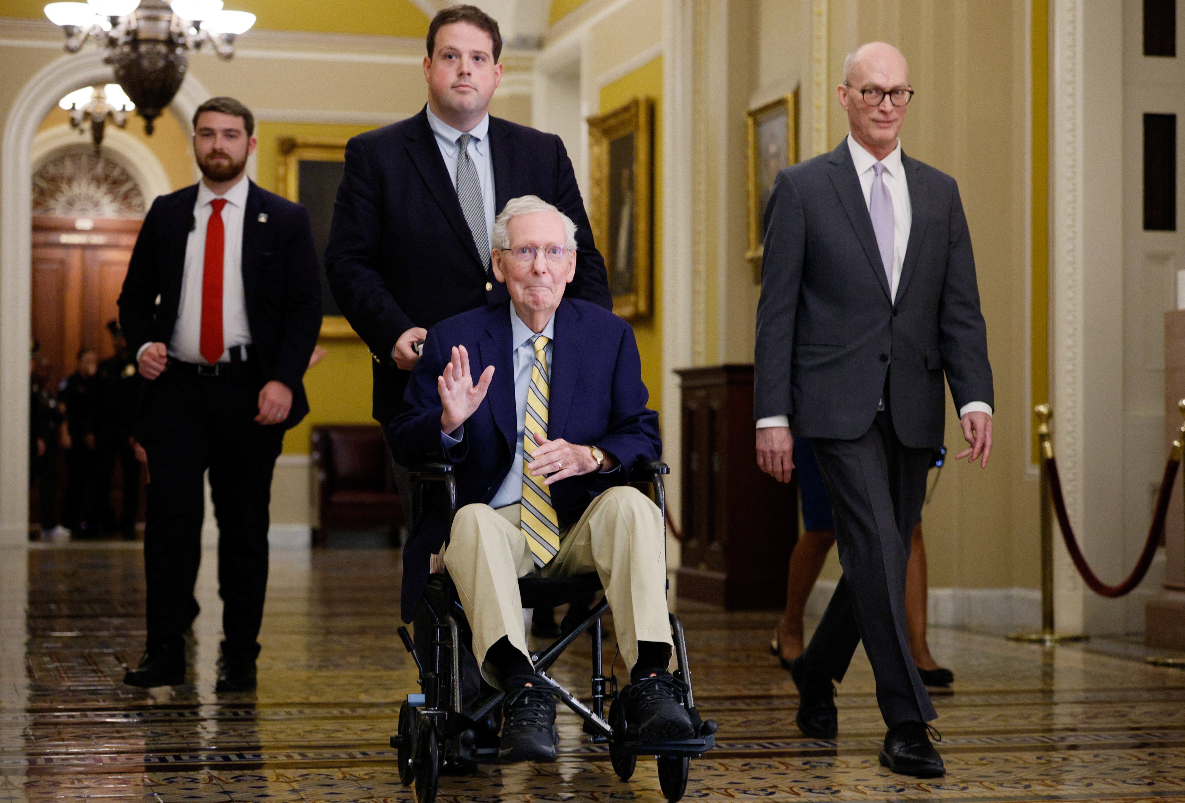 US Senator Mitch McConnell waves at reporters outside the Senate Chamber. Photo: Reuters