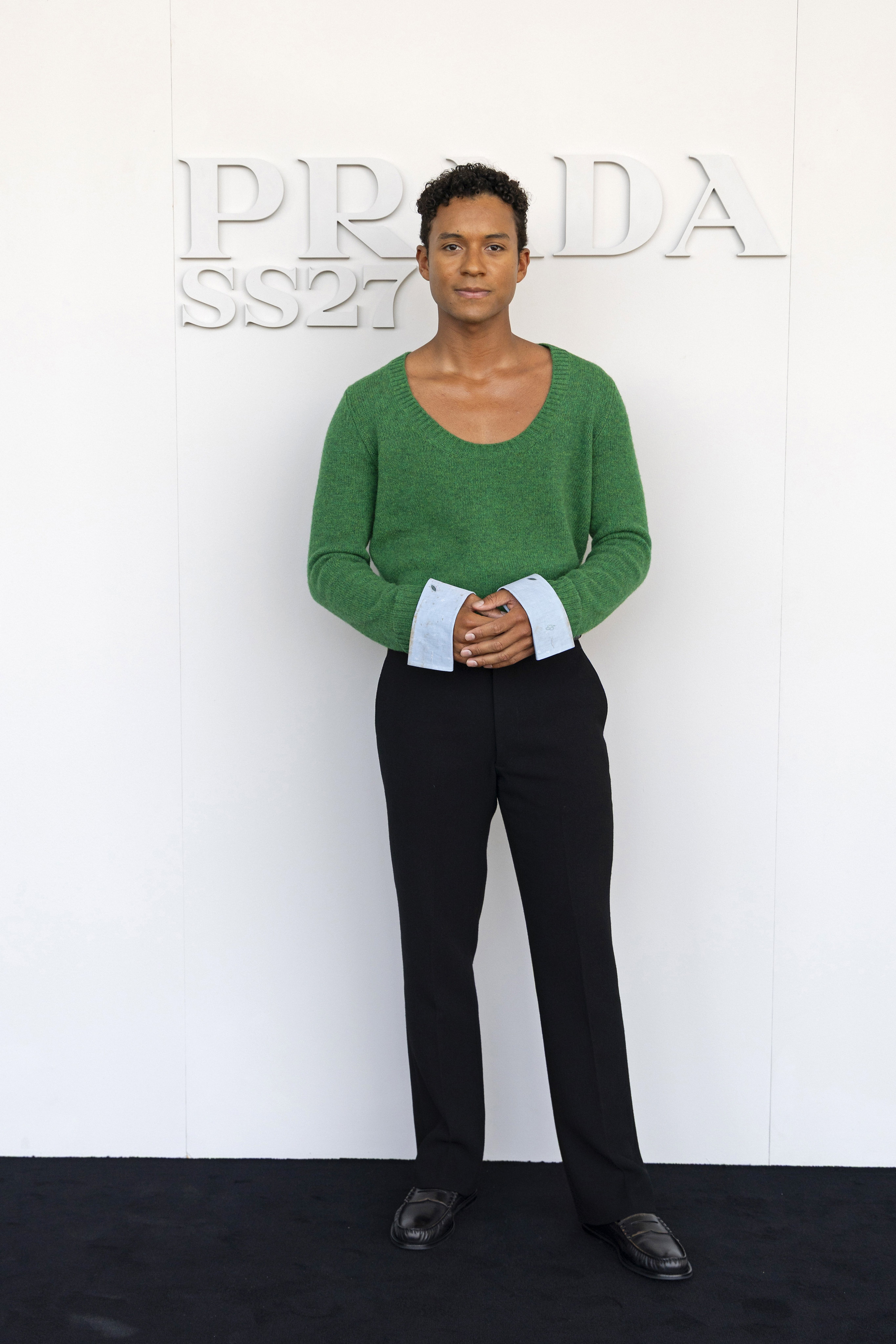Jaafar Jackson wears a green knit top and tailored black trousers at the Prada spring/summer 2027 menswear show in Milan on June 21. Photo: Getty Images
