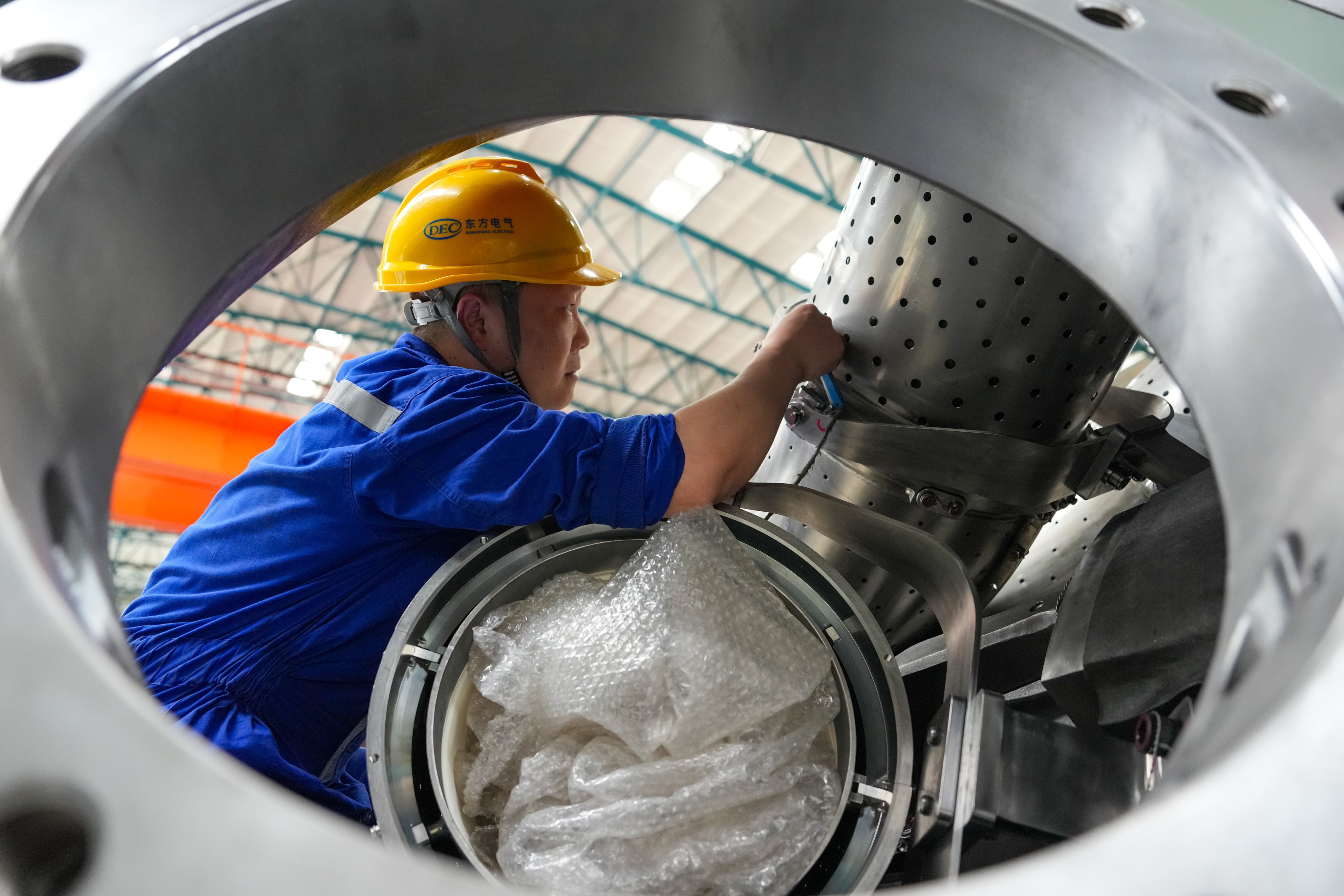 A worker assembles an industrial turbine at a factory in China’s Sichuan province in June. Photo: Xinhua