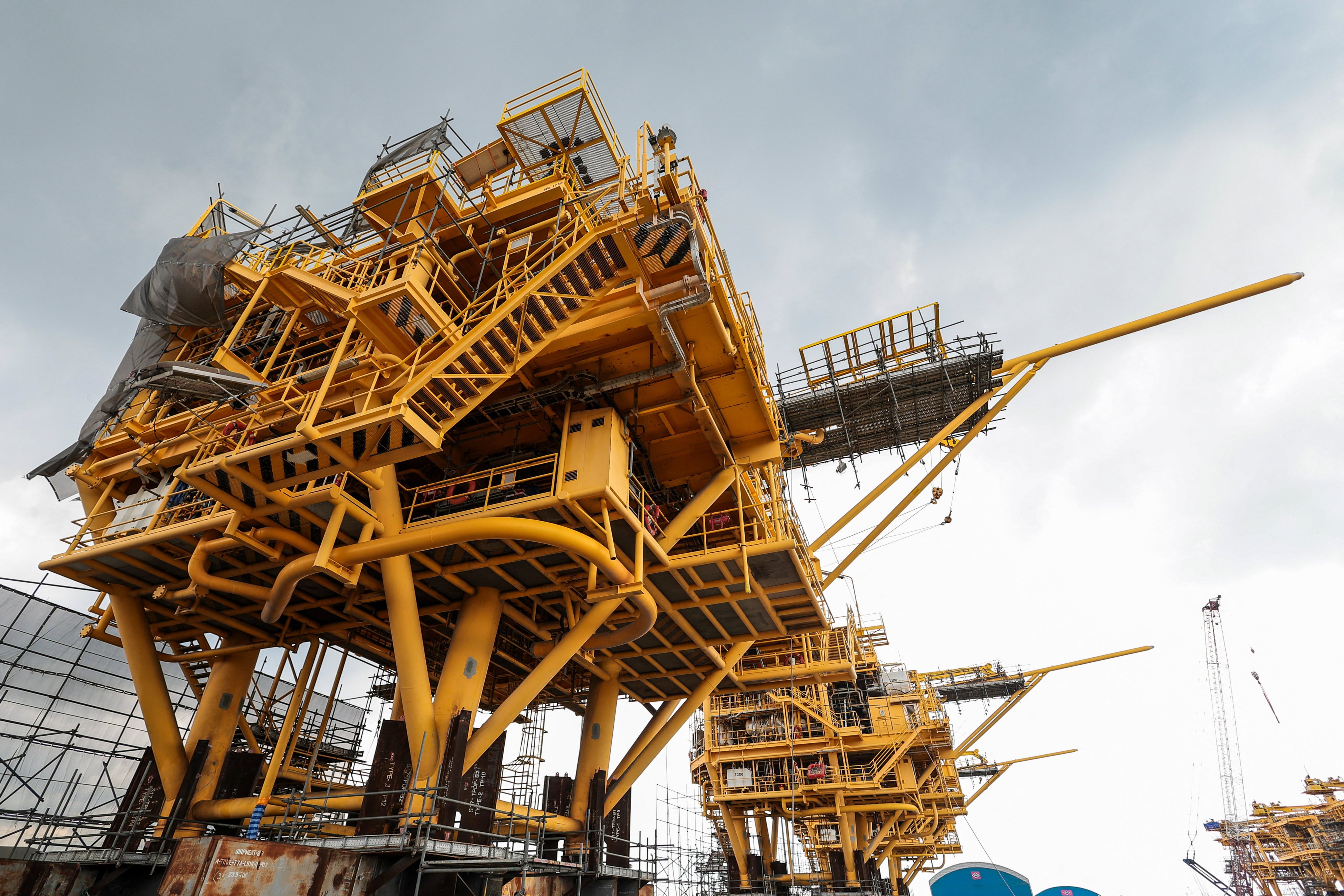 Wellhead platforms, used for the offshore extraction of oil and gas, undergo refurbishment at a port in Chonburi province, Thailand, last week. Photo: Reuters