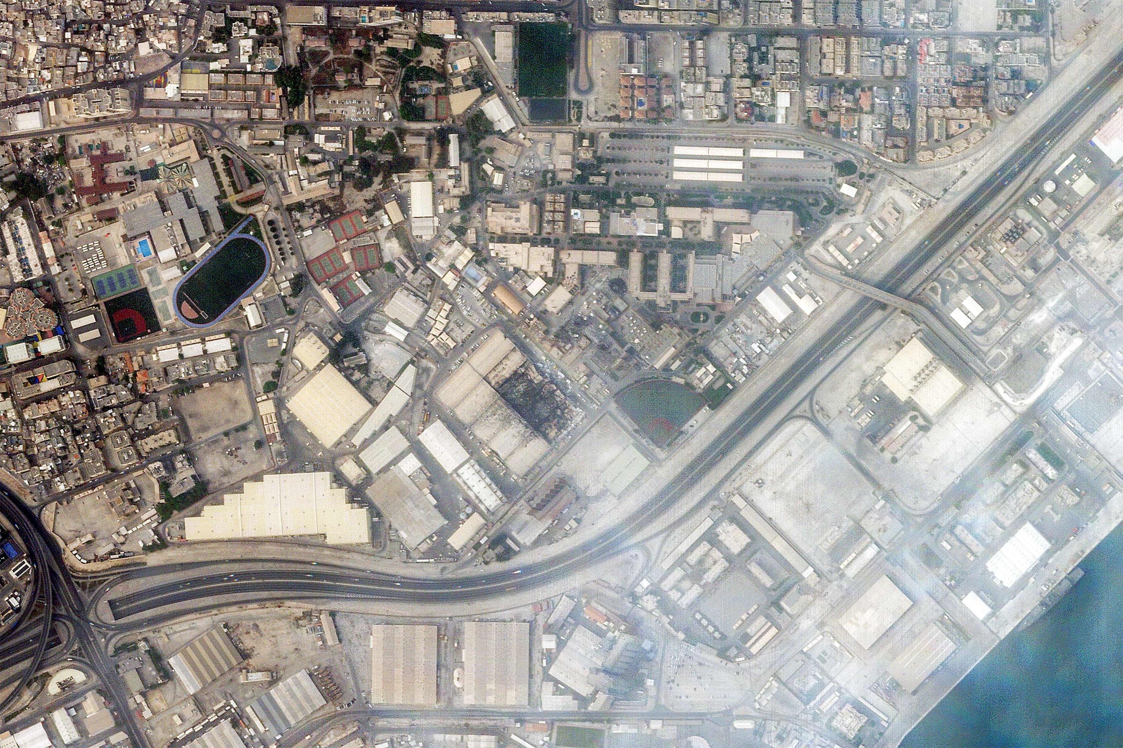 Smoke rises from damage at the US Fifth Fleet naval base in Manama, Bahrain, after Iranian strikes, in a satellite photo taken March 1, 2026. Photo: Planet Labs PBC via AFP