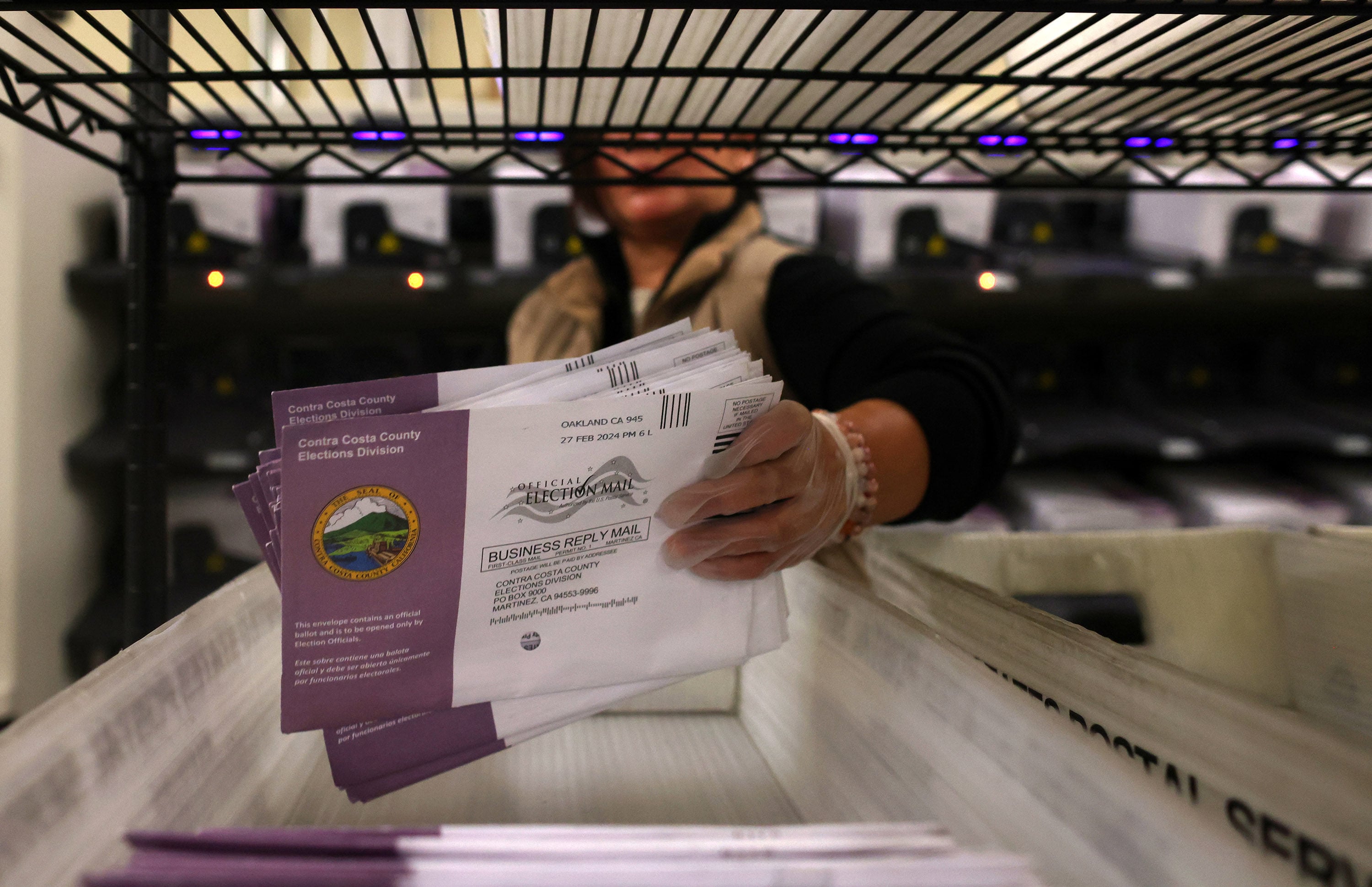 An election worker sorts mail-in ballots in 2024. Photo: TNS