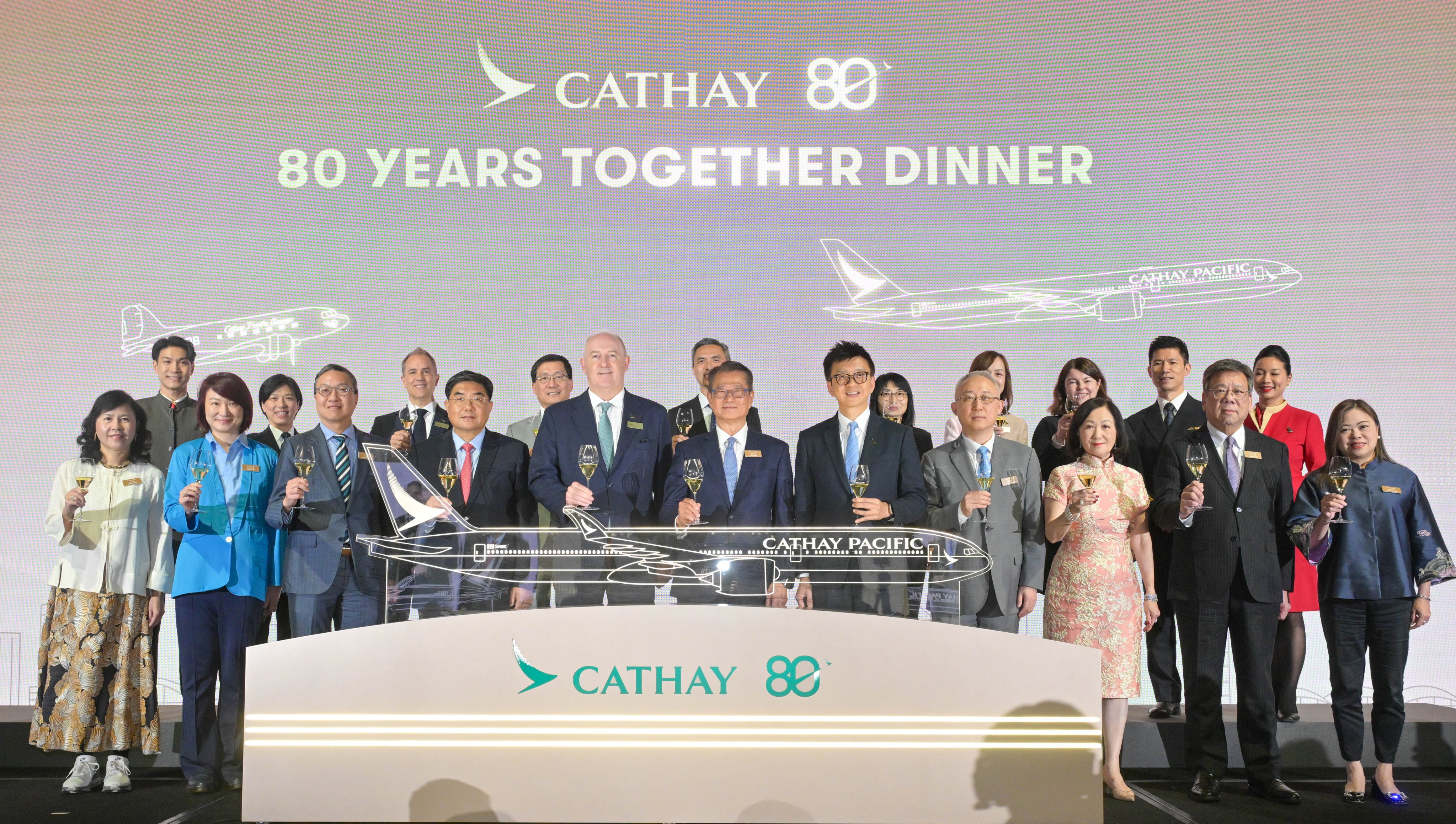 Financial Secretary Paul Chan (centre), flanked by Cathay Group chairman Guy Bradley (right) and CEO Ronald Lam (left), raises a toast alongside other political and business heavyweights at the event. Photo: Handout
