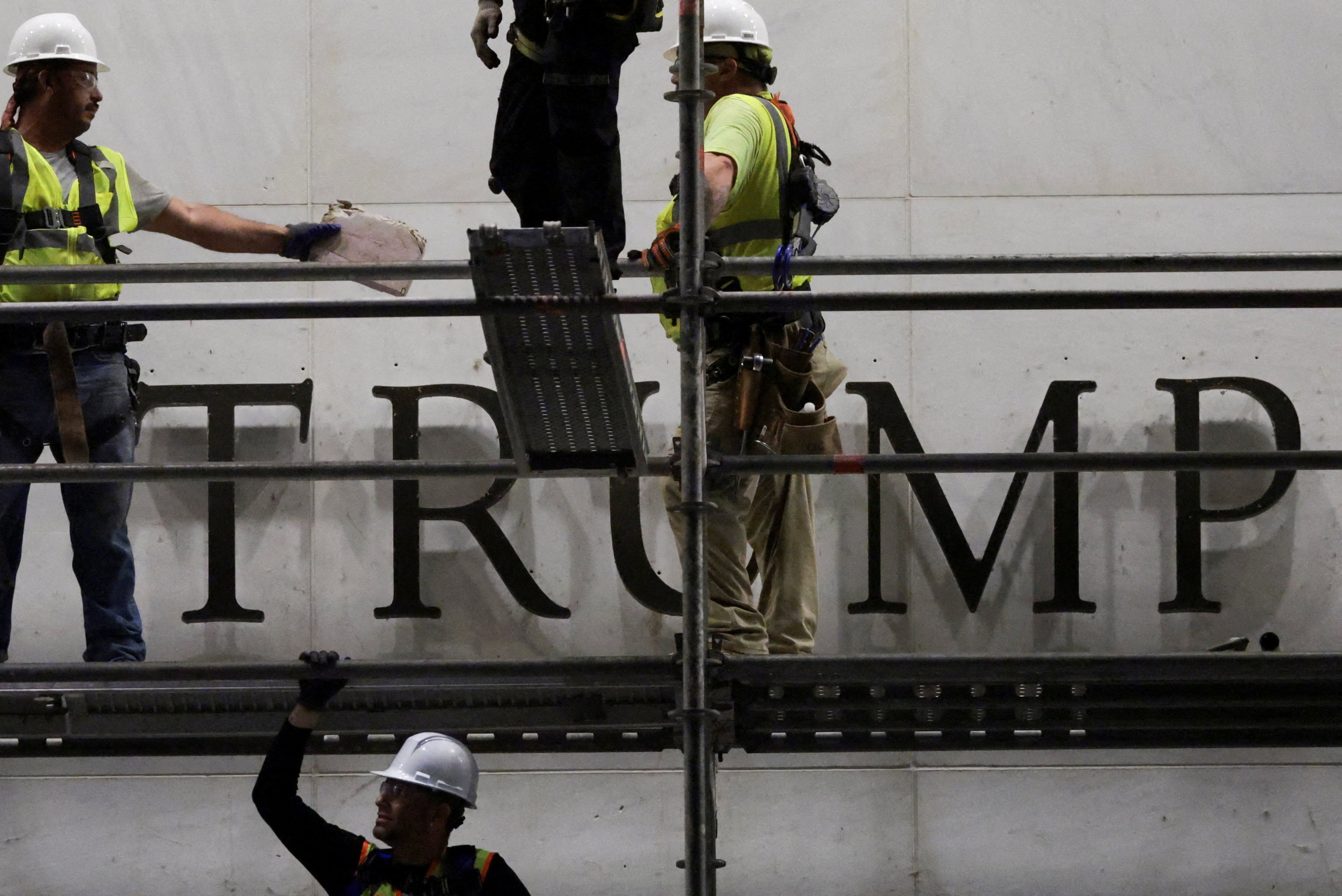 Workers prepare scaffolding before removing lettering from the facade of the Kennedy Centre in June. Photo: Reuters