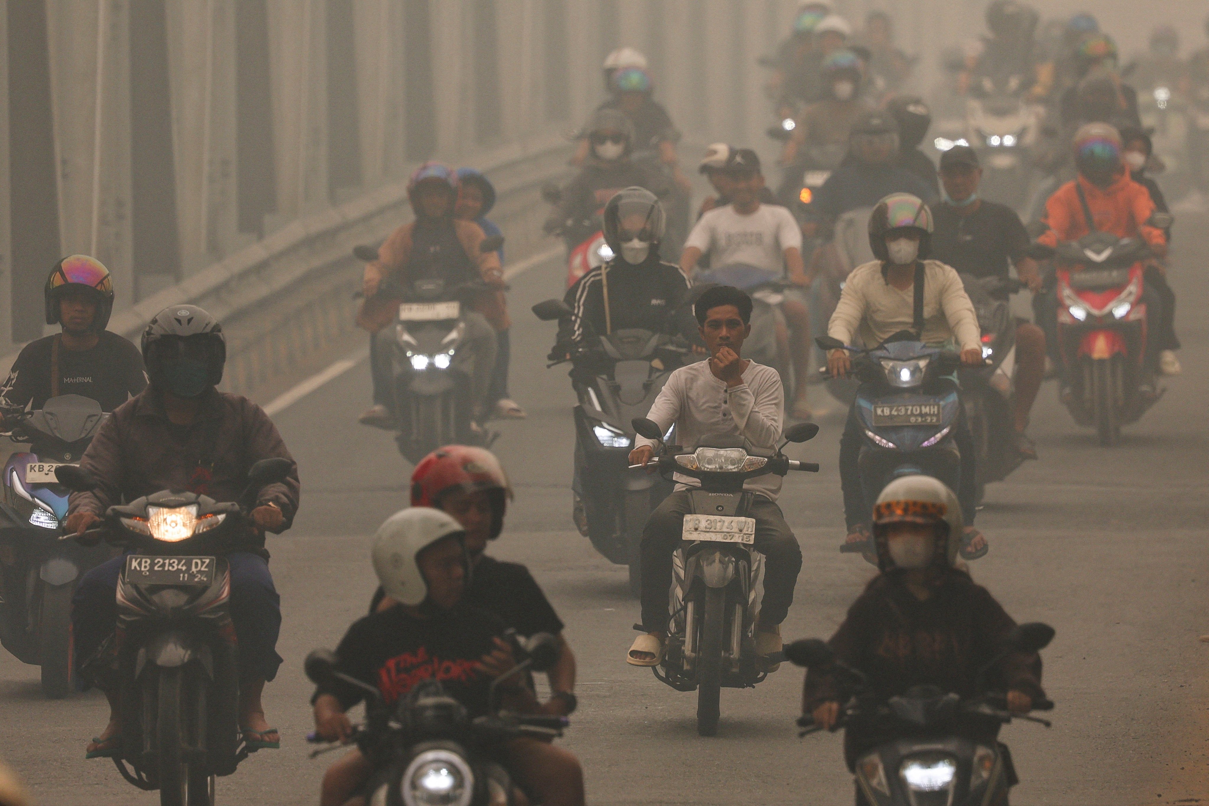 People ride motorcycles amid haze from wildfires in Pontianak, Indonesia’s West Kalimantan province, Indonesia, on Wednesday. Photo: Reuters