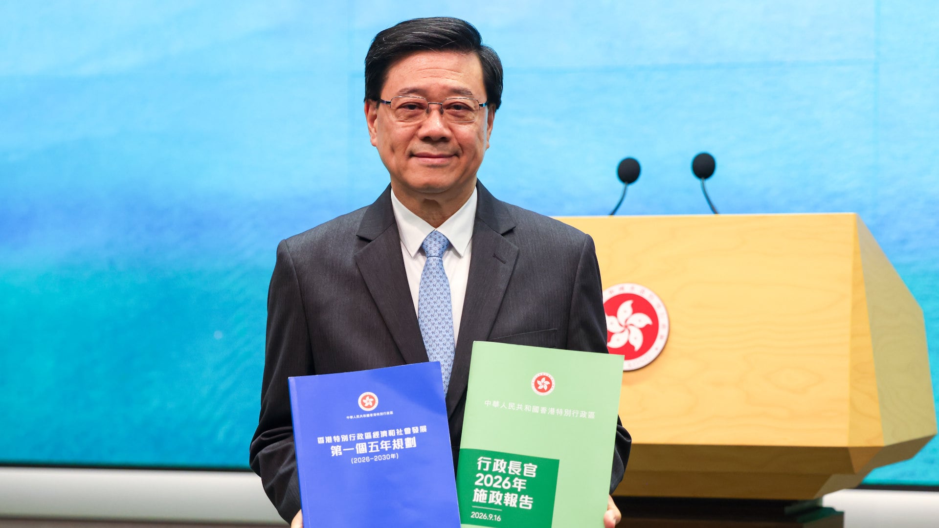 Chief Executive John Lee Ka-chiu speaks to the media before an Executive Council meeting at the Central Government Offices in Admiralty. Lee held up copies of upcoming official publications, highlighting that the cover of the first Five-Year Plan is blue, while the Policy Address retains its iconic green design. 15SEP26 SCMP / Silvia Siu