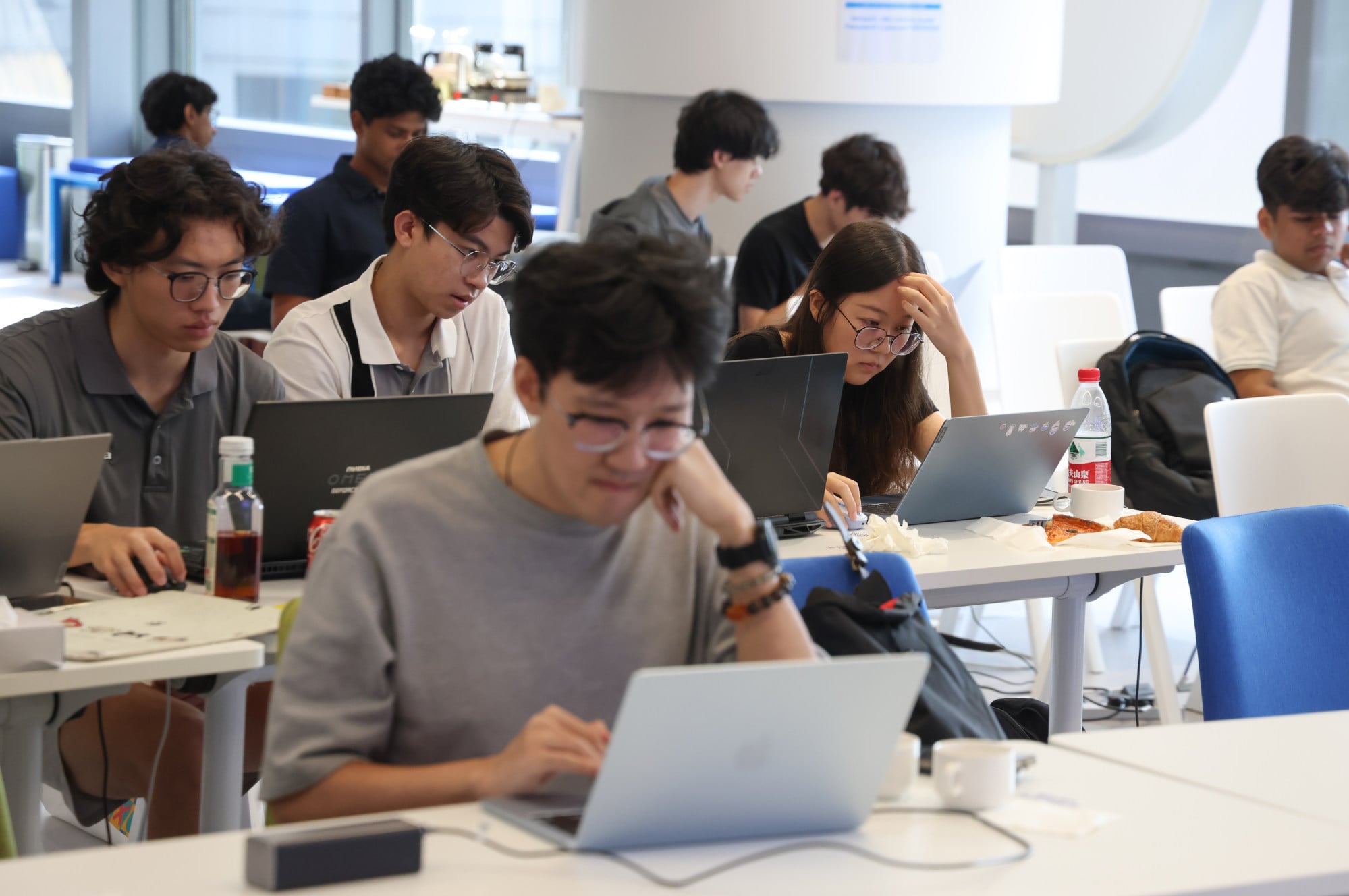 Students and software builders collaborate on AI projects during a global hackathon at Cyberport in Pok Fu Lam. Photo: Silvia Siu