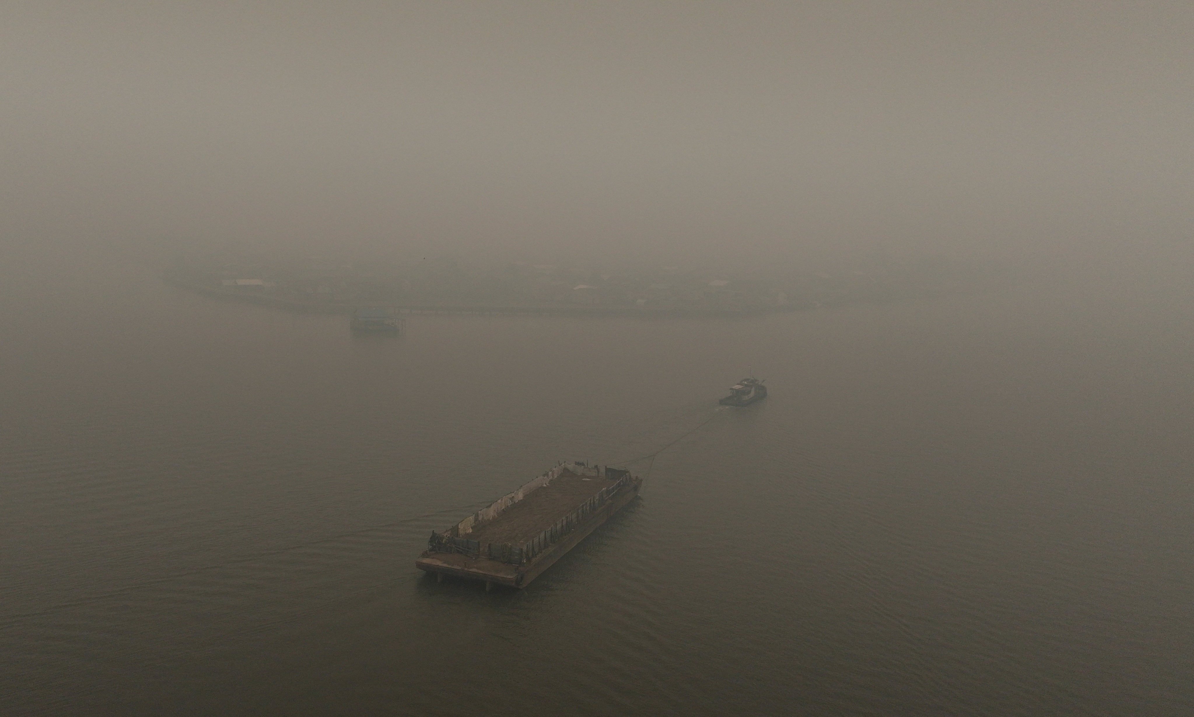 A drone view shows a barge being towed along the Kapuas River, shrouded in haze from wildfires, in Pontianak, Indonesia’s West Kalimantan province, Indonesia, on Tuesday. Photo: Reuters