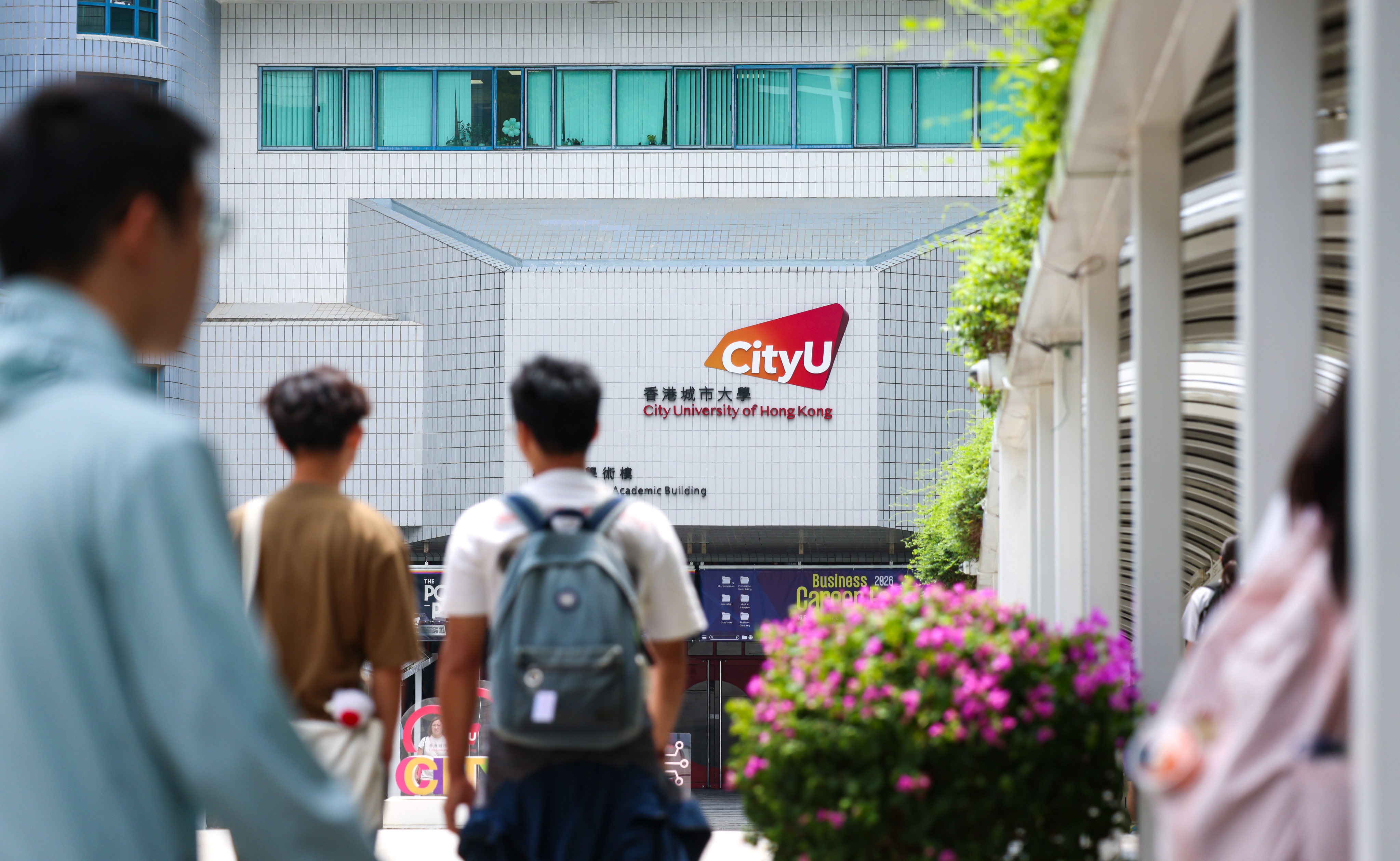 Students and staff pass through the main entrance of City University in Kowloon Tong on September 8. Photo: Silvia Siu