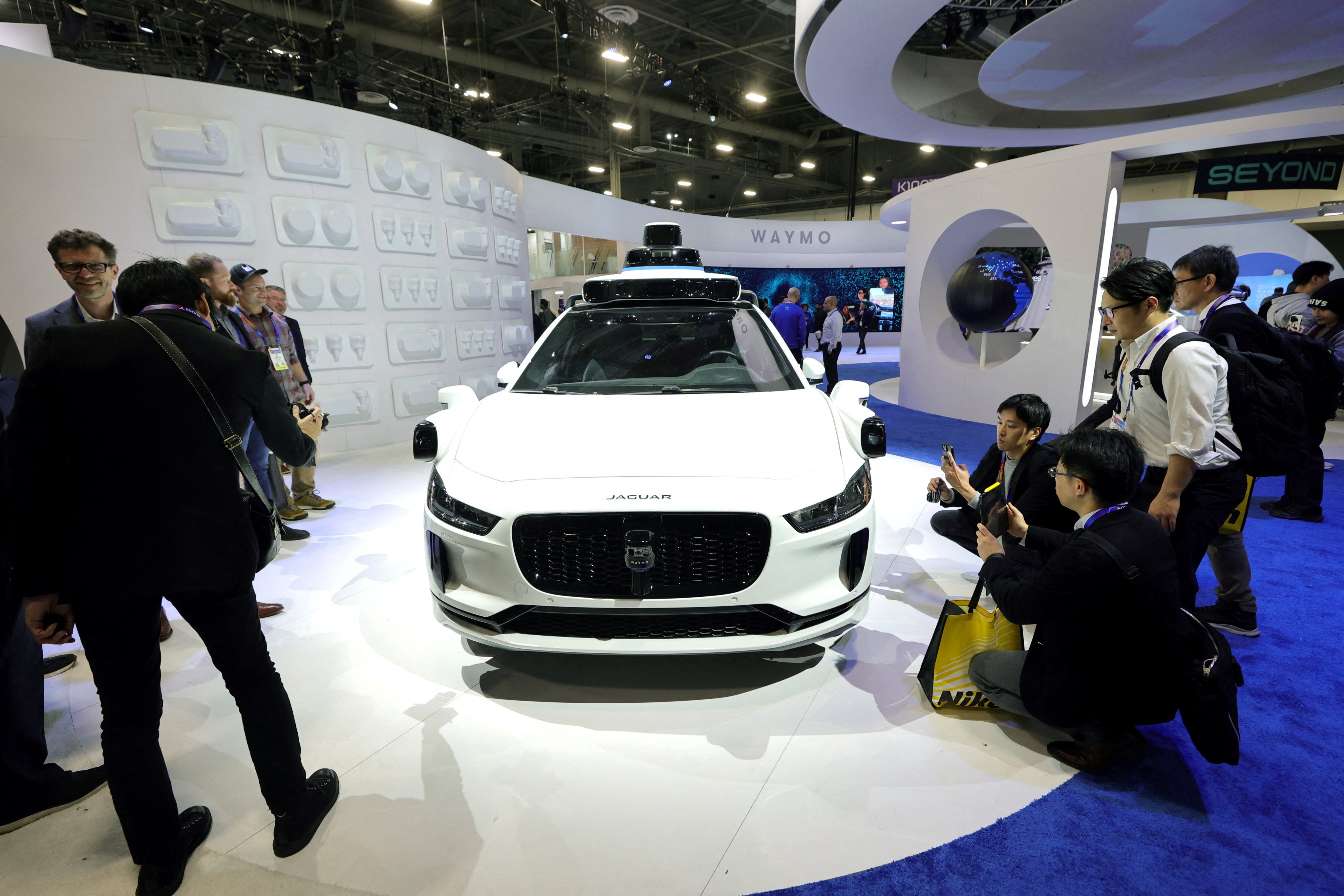 Attendees look at a Jaguar I-Pace equipped with a Waymo autonomous driving system at a consumer electronics trade show in Las Vegas in January 2025. Photo: Reuters
