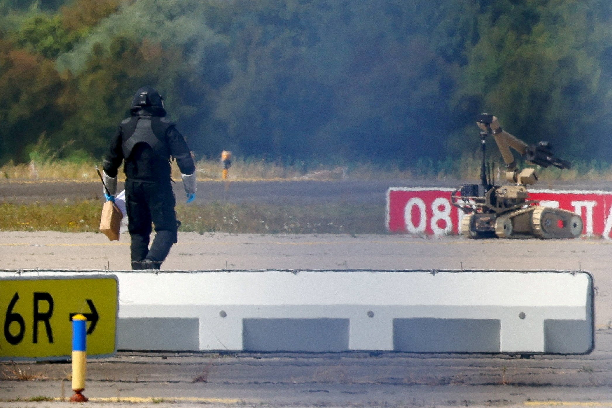 A police officer walks next to an explosive-disarming robot at Germany’s Leipzig airport last month after a drone was found near a runway. Photo: Reuters