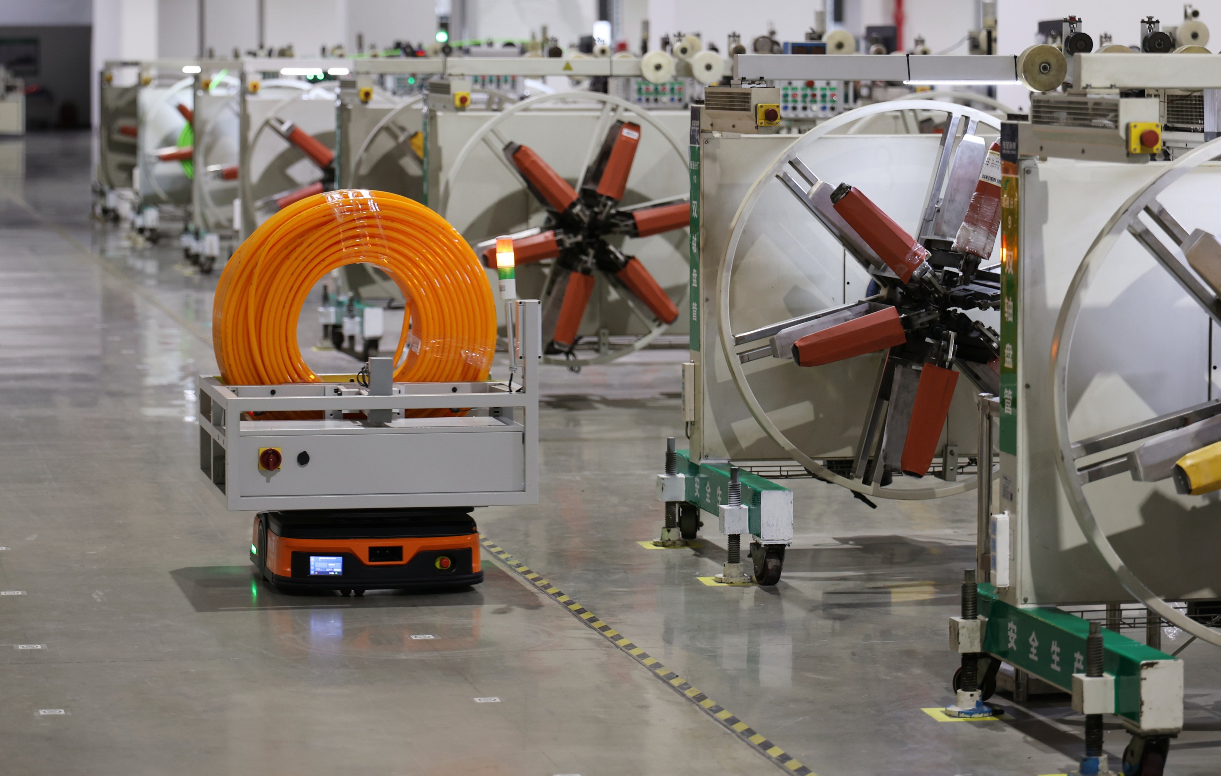 An automated guided vehicle operates at the workshop of a building-materials company in northern China's Tianjin last month. The nation is looking to build more smart factories. Photo: Xinhua