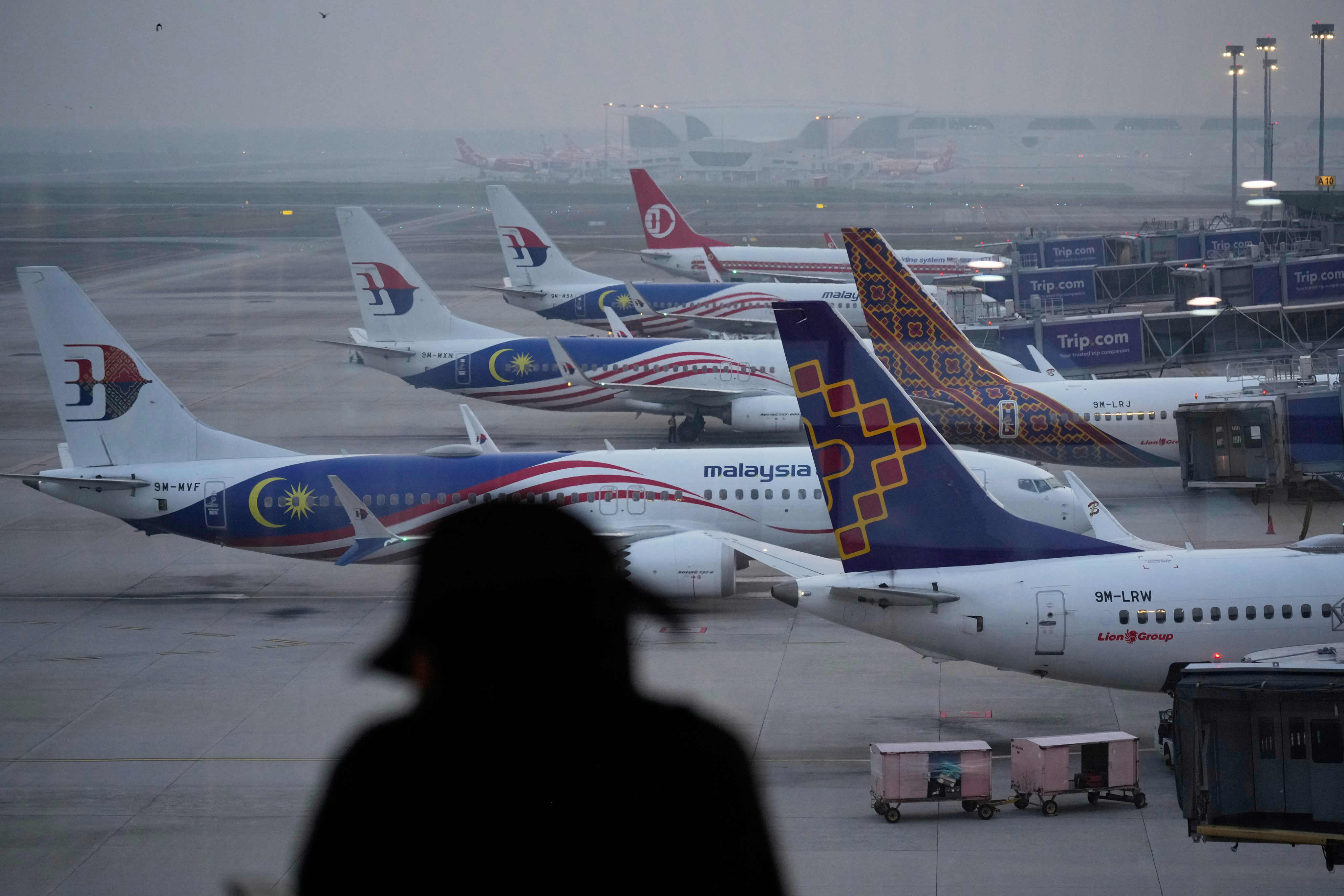 A person looks at parked Malaysia Airlines planes amid haze at Malaysia’s Kuala Lumpur International Airport on Tuesday. Photo: AP