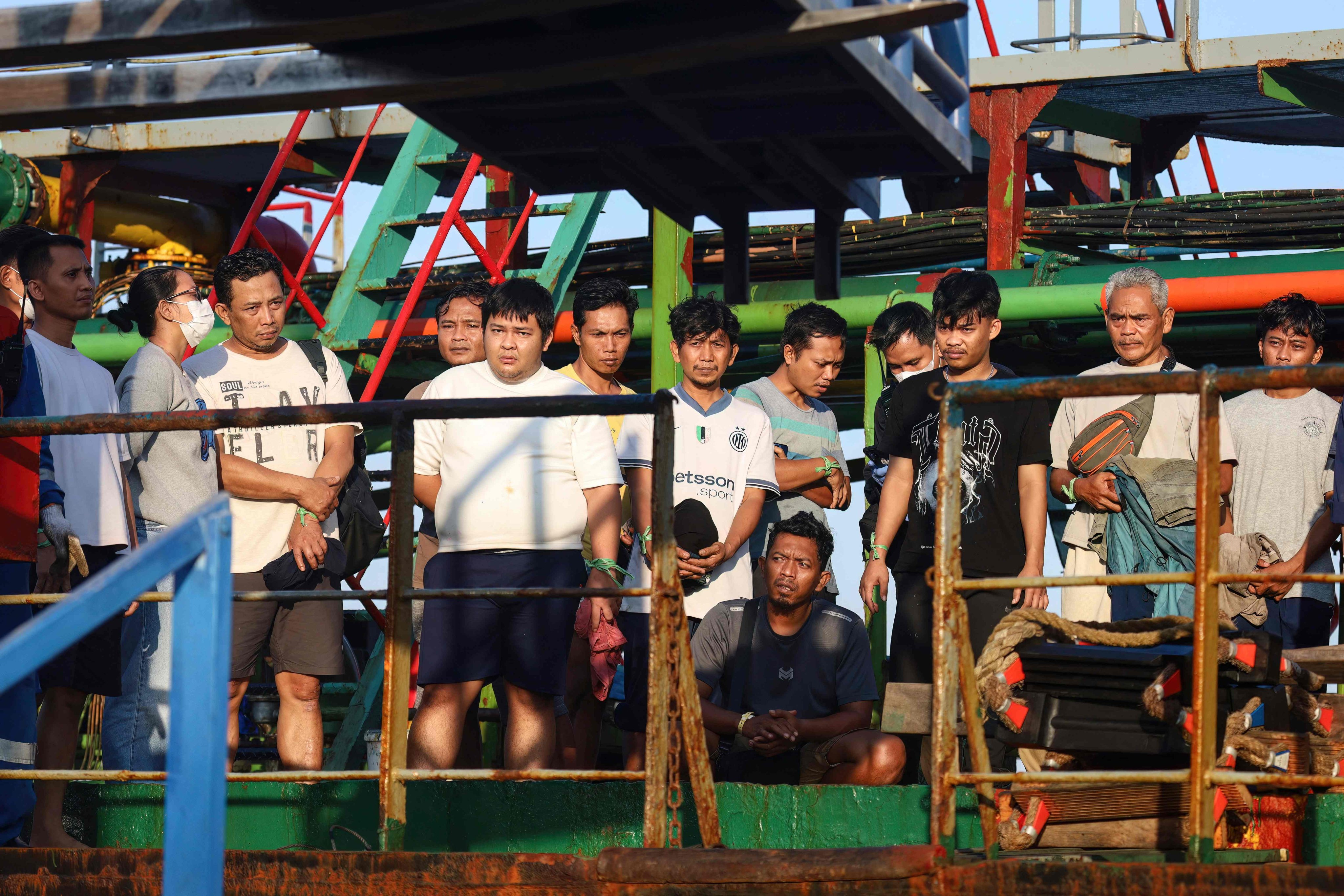 Survivors of the Virgo Transport 8 passenger ferry, which capsized on Sunday while en route from Banjarmasin to Surabaya, wait to disembark following their rescue at the port in Banjarmasin, South Kalimantan, on Monday. Photo: AFP