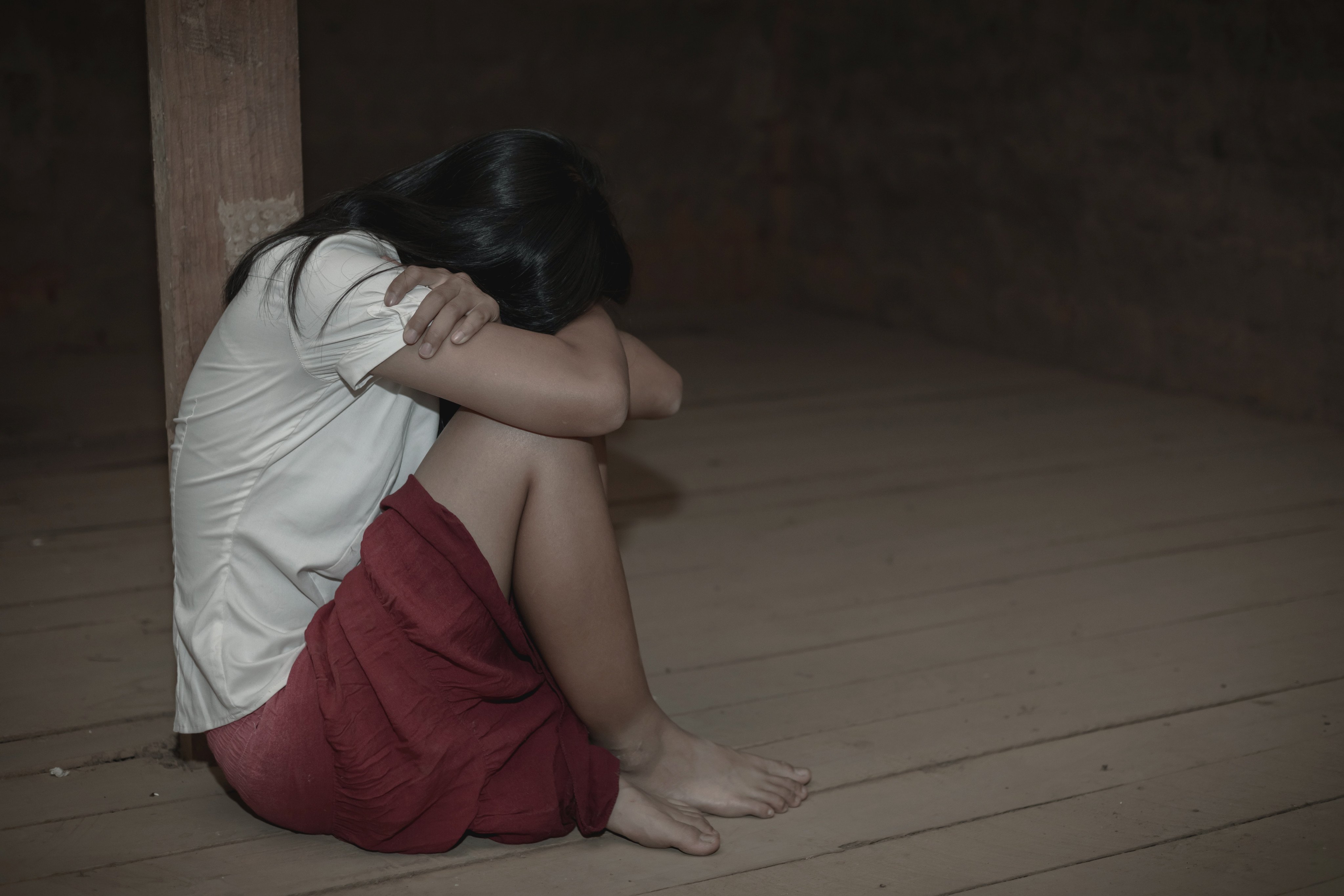 A young girl sobs in an empty room. The victims of the 71-year-old man were as young as five, and included his daughter, granddaughters, nieces and students at an enrichment centre he ran with his wife. Photo: Shutterstock