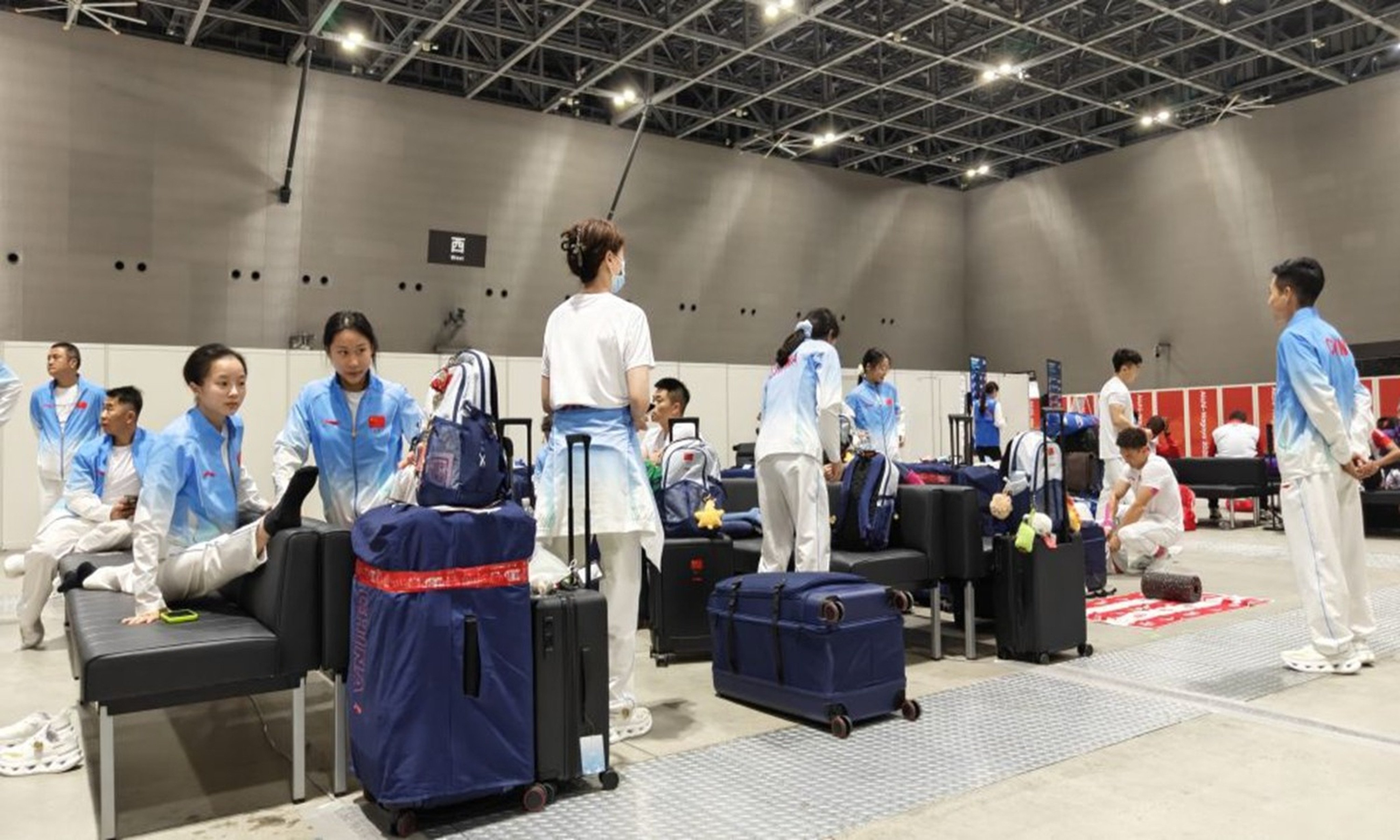 Members of the Chinese gymnastics team try and stay relaxed during their long wait Nagoya airport. Photos: Xinhua