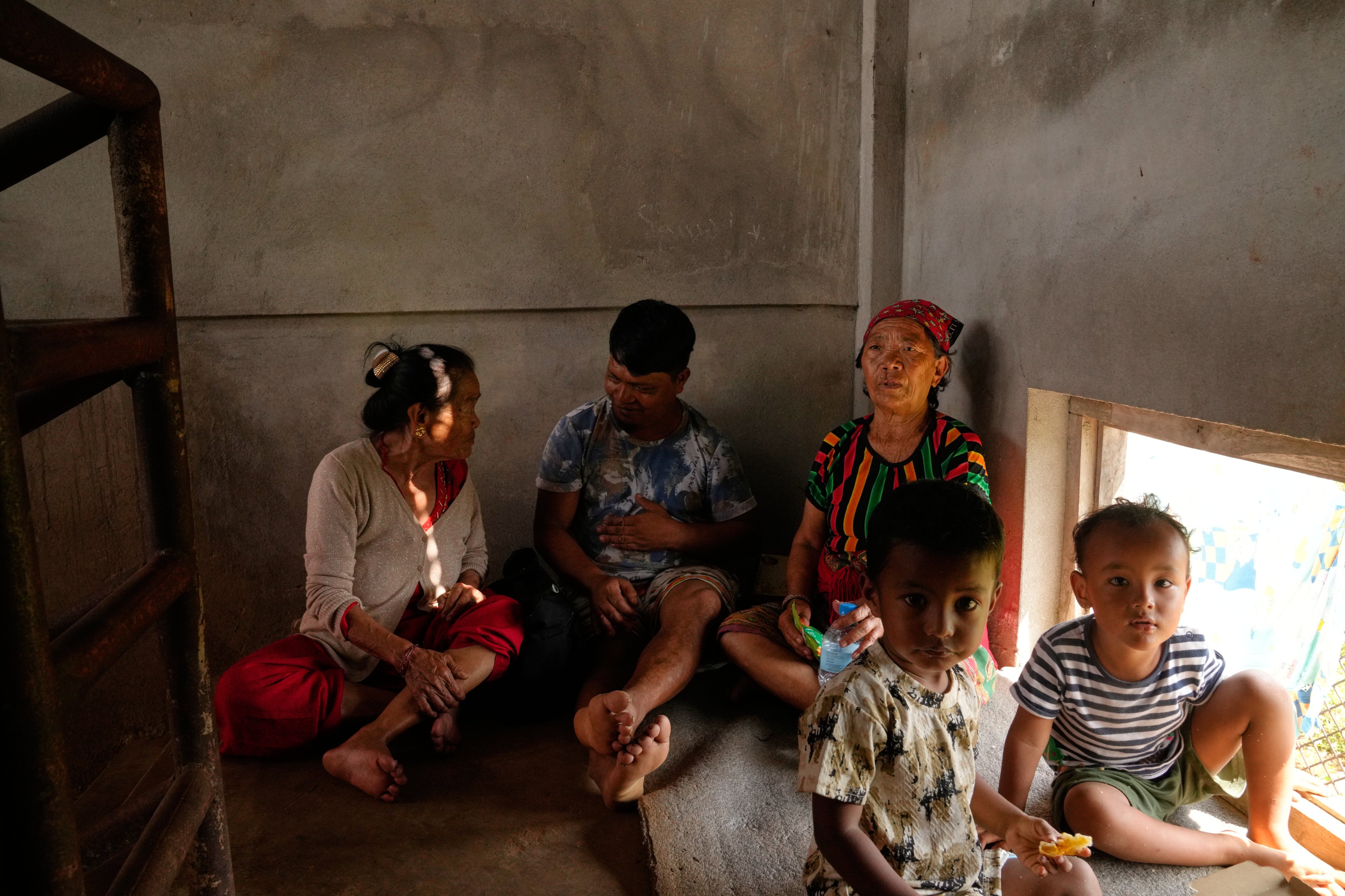 Children displaced by recent flash floods sit inside a temporary shelter set up at a school in Nepal’s Nuwakot district, in September. Photo: AP