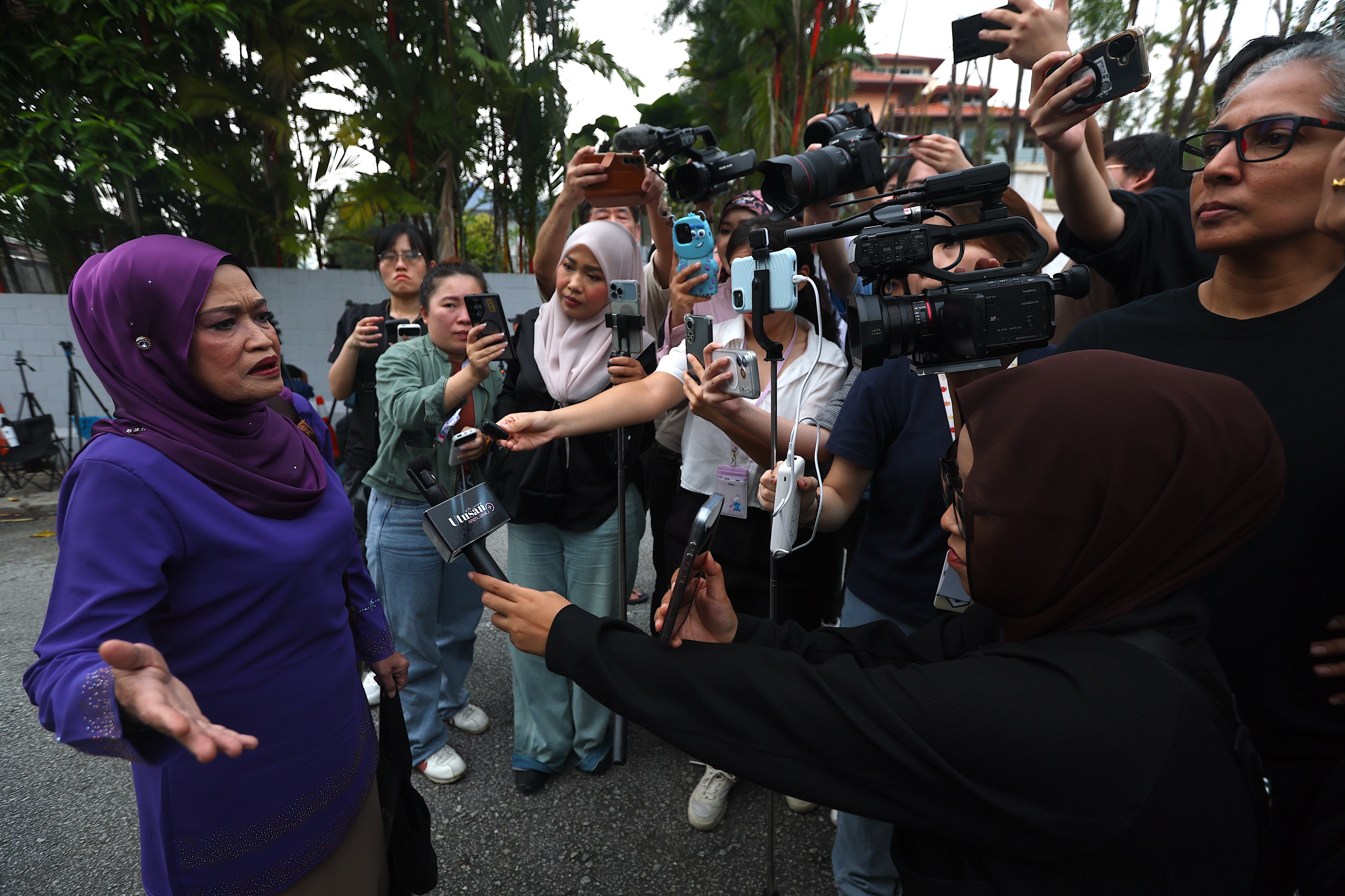 A supporter (left) of Najib Razak speaks to the media outside the former prime minister’s house in Kuala Lumpur on Friday. Photo: EPA