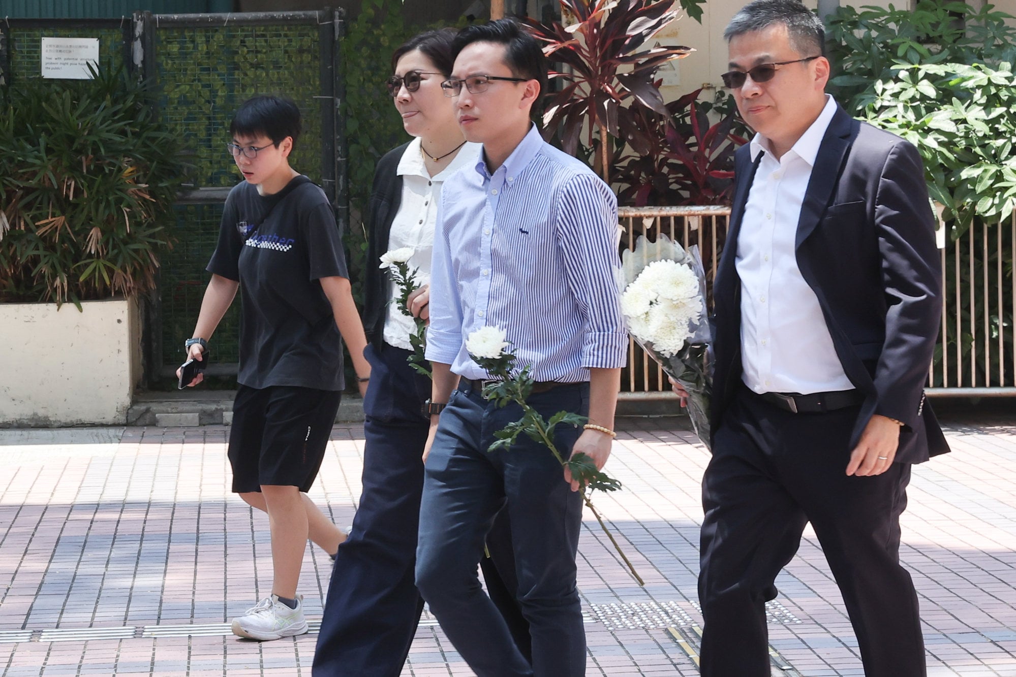 District councillor Nicholas Muk (second from right) and lawmaker Ng Wun-kit (right) arrive at Moreton Terrace Activities Centre in Causeway Bay. Photo: Edmond So District councillor Nicholas Muk (second from right) and lawmaker Ng Wun-kit (right) arrive at Moreton Terrace Activities Centre in Causeway Bay. Photo: Edmond So