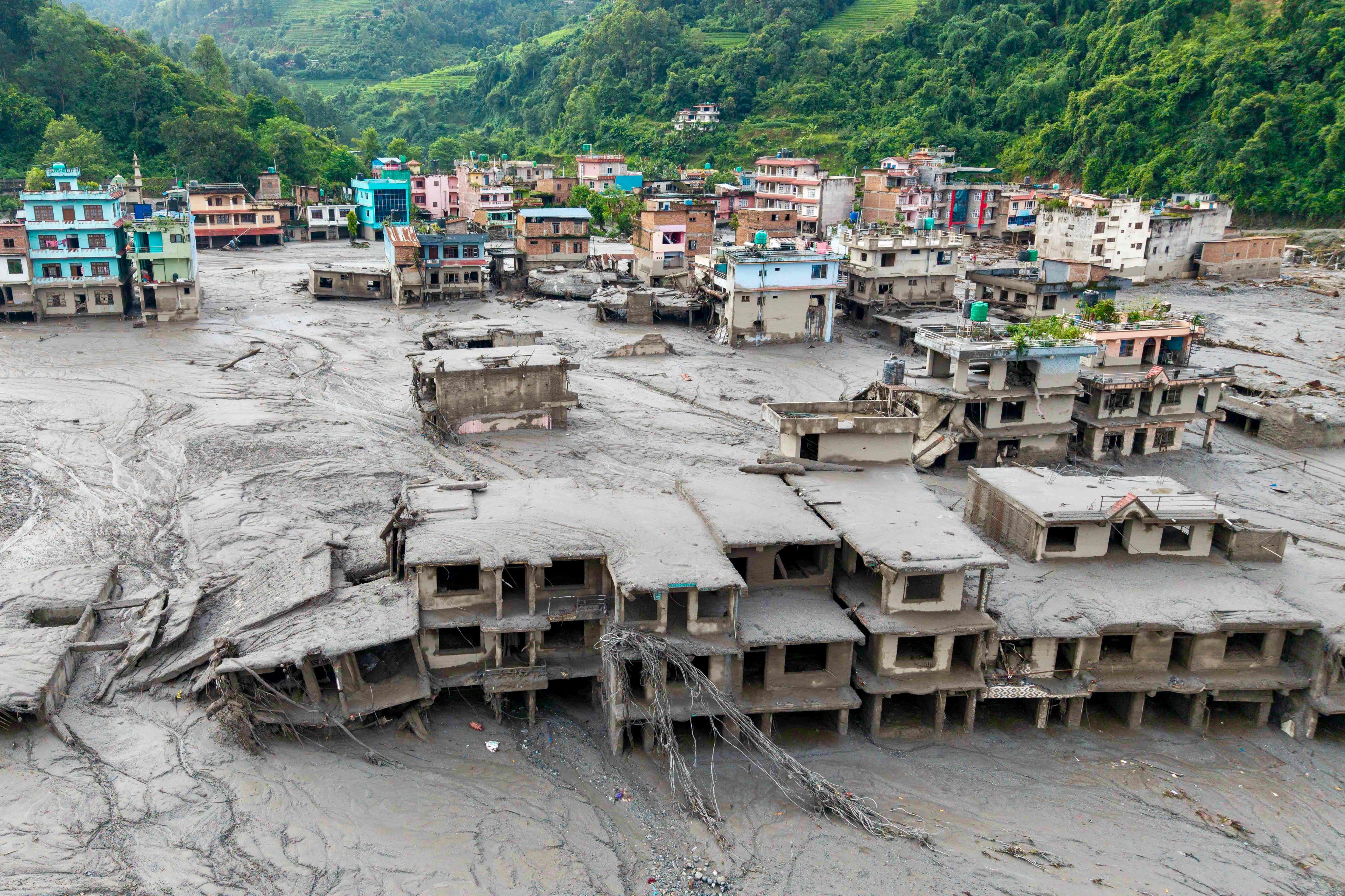 Houses buried in mud after flash floods in Nepal’s Nuwakot district in August. The August 26 tsunami-like surge of water, mud and debris from a glacial mountain collapse on the China-Nepal border has left more than 5,650 missing. Photo: AFP