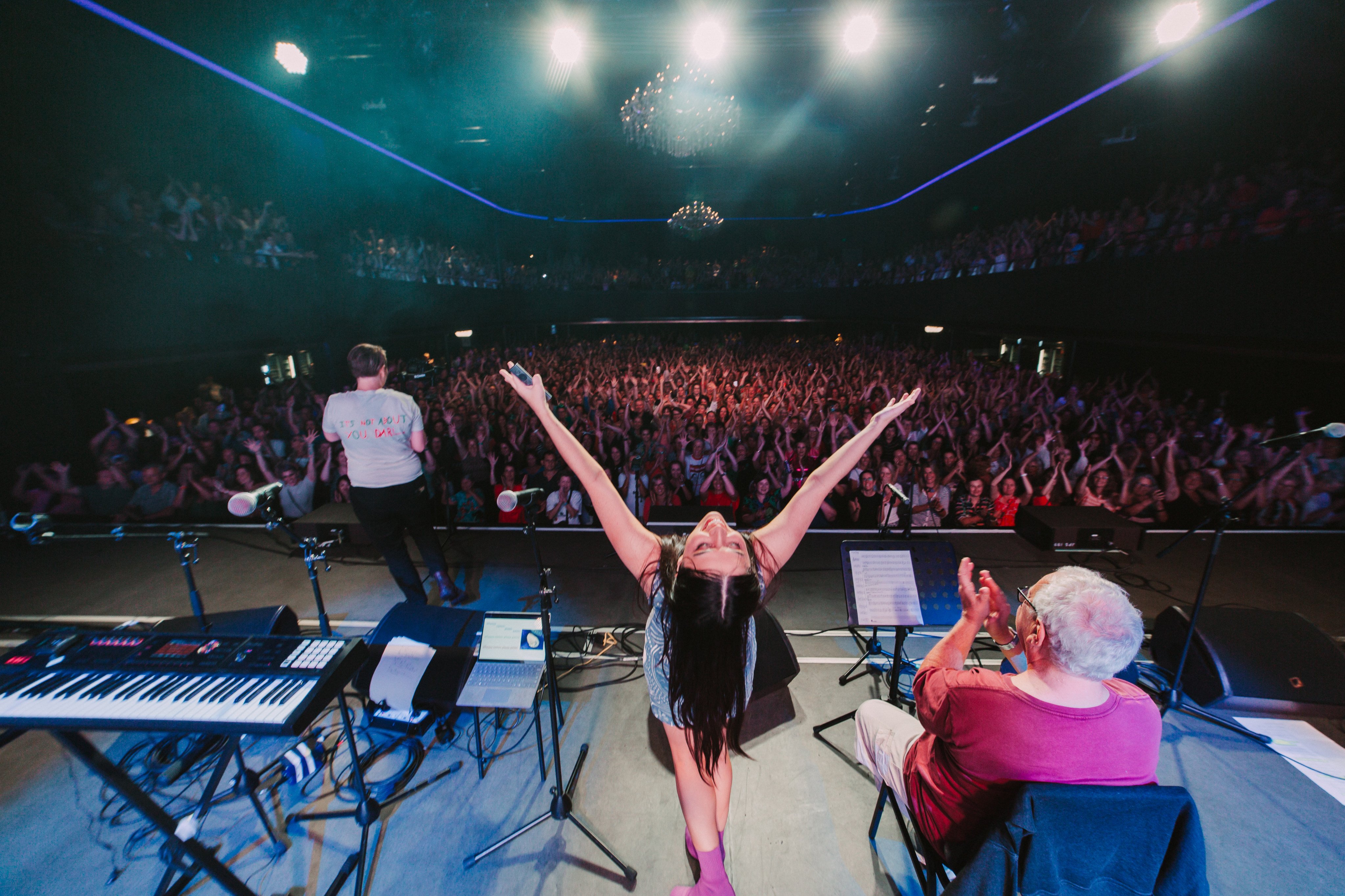 Pub Choir founder Astrid Jorgensen (centre) gestures at the crowd during a show in Brisbane, Australia, in 2023. Photo: Pub Choir